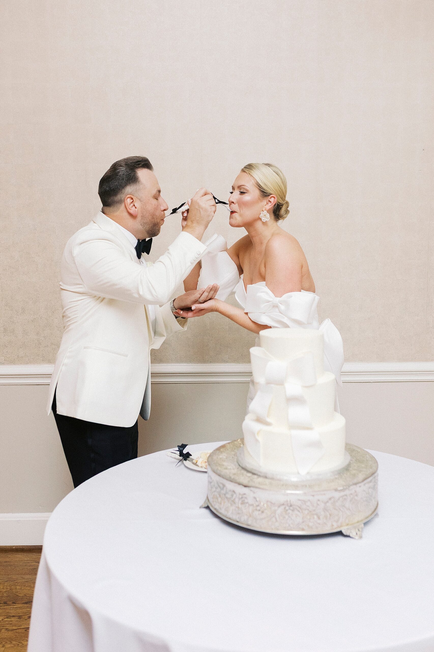 newlyweds feed each other cake