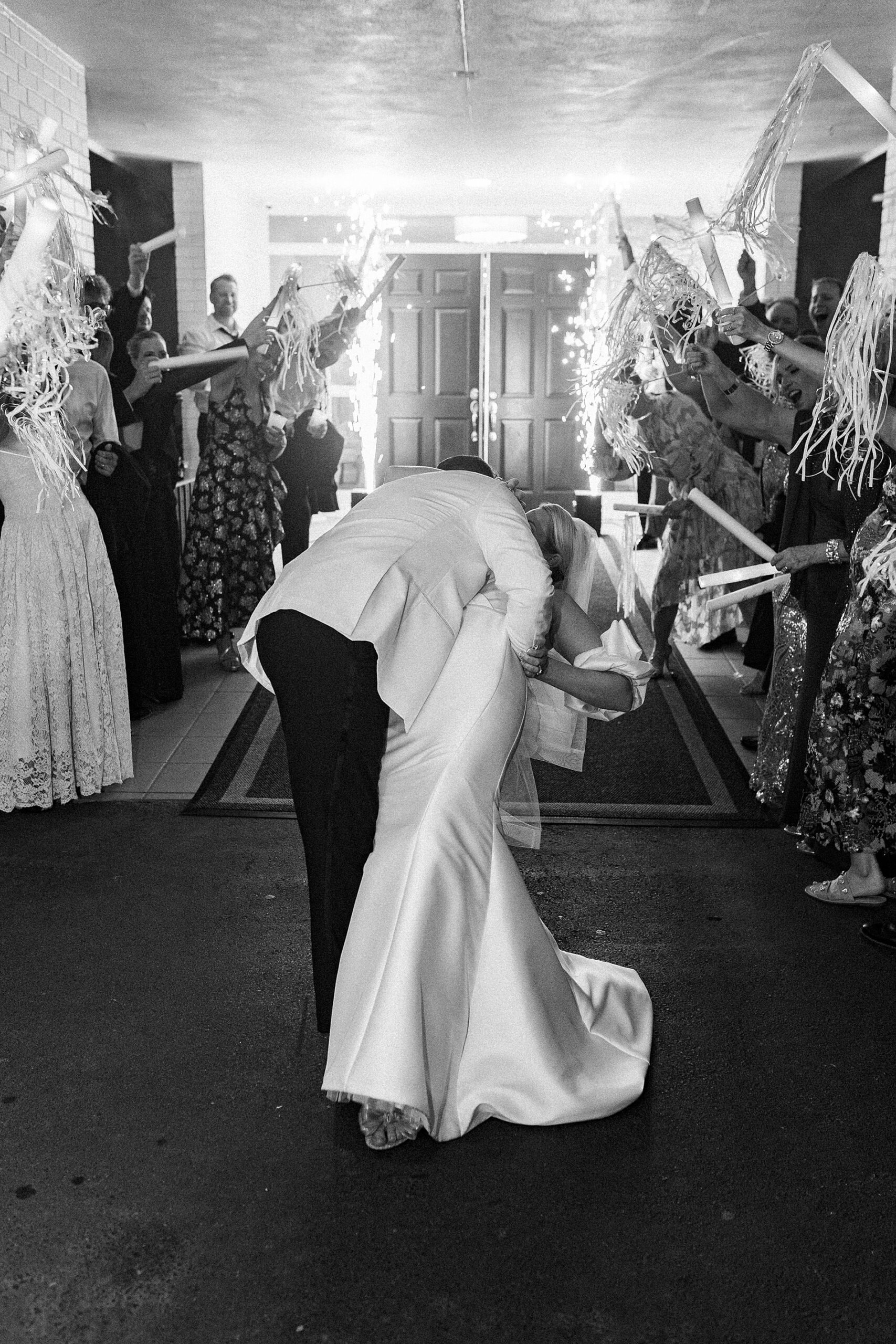 newlyweds kiss during wedding exit at Gaston Country Club