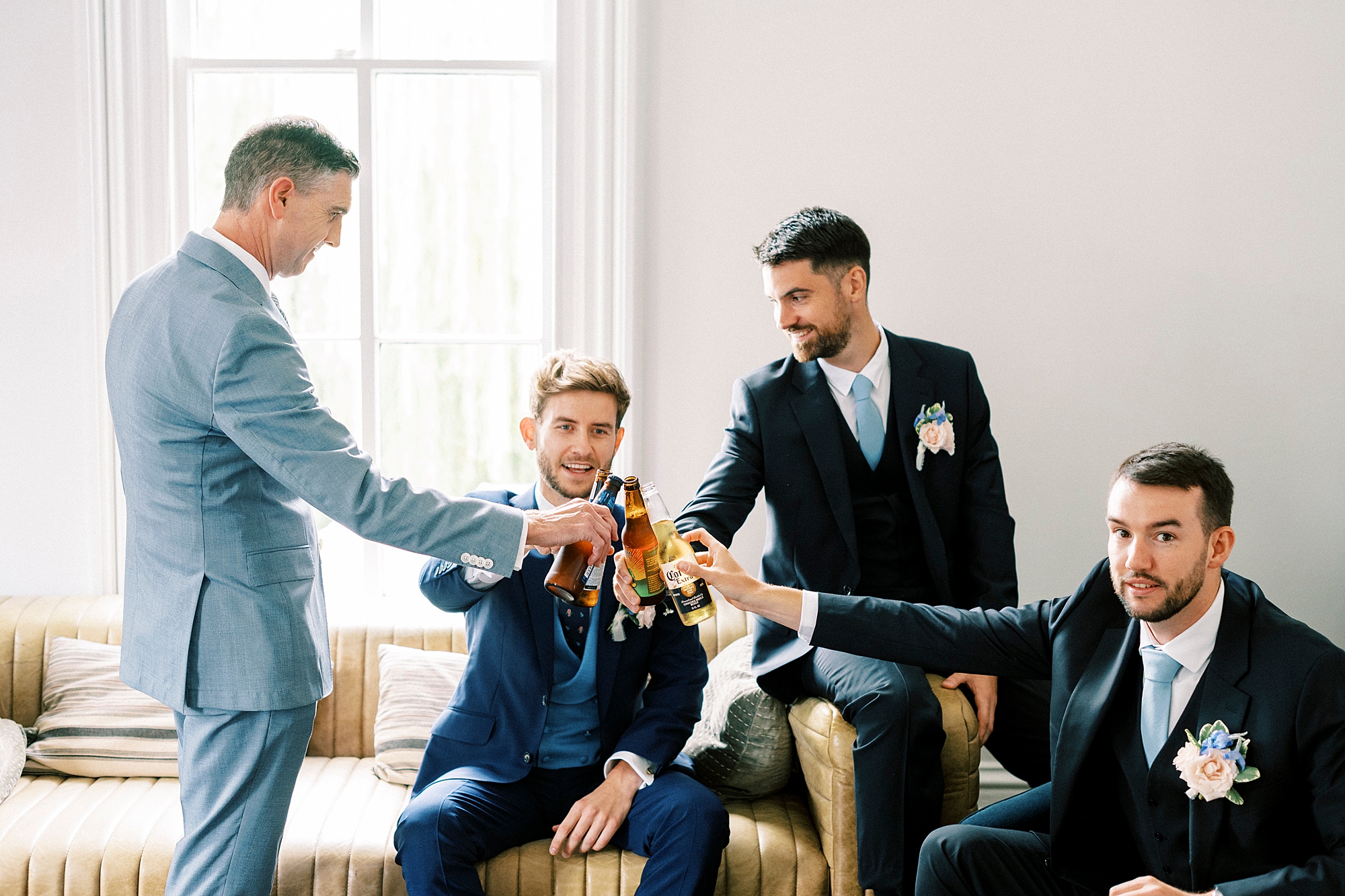 groom and groomsmen sharing a toast
