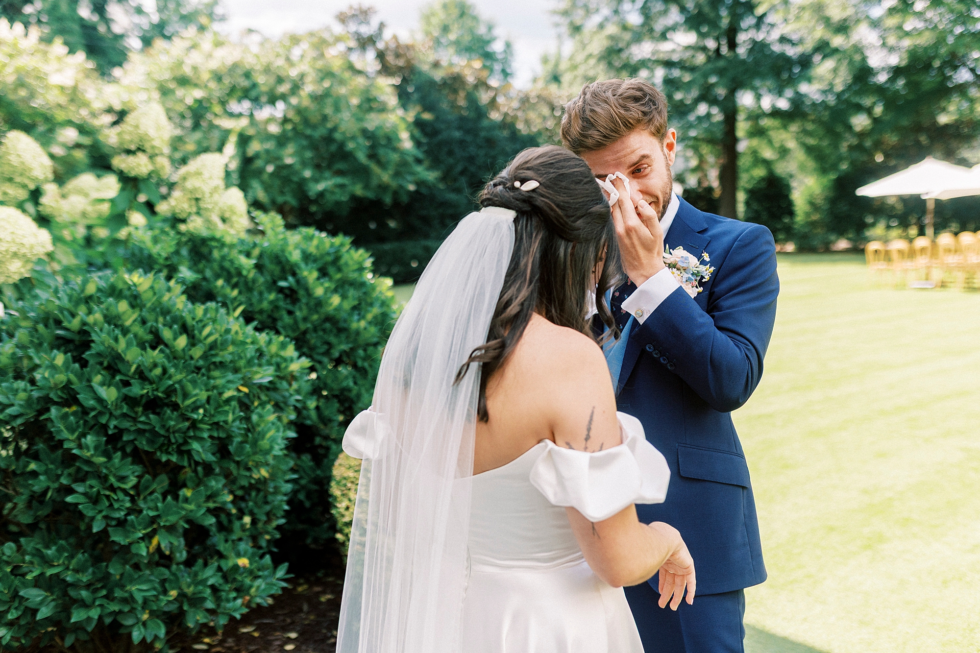 groom wipes away tears during first look