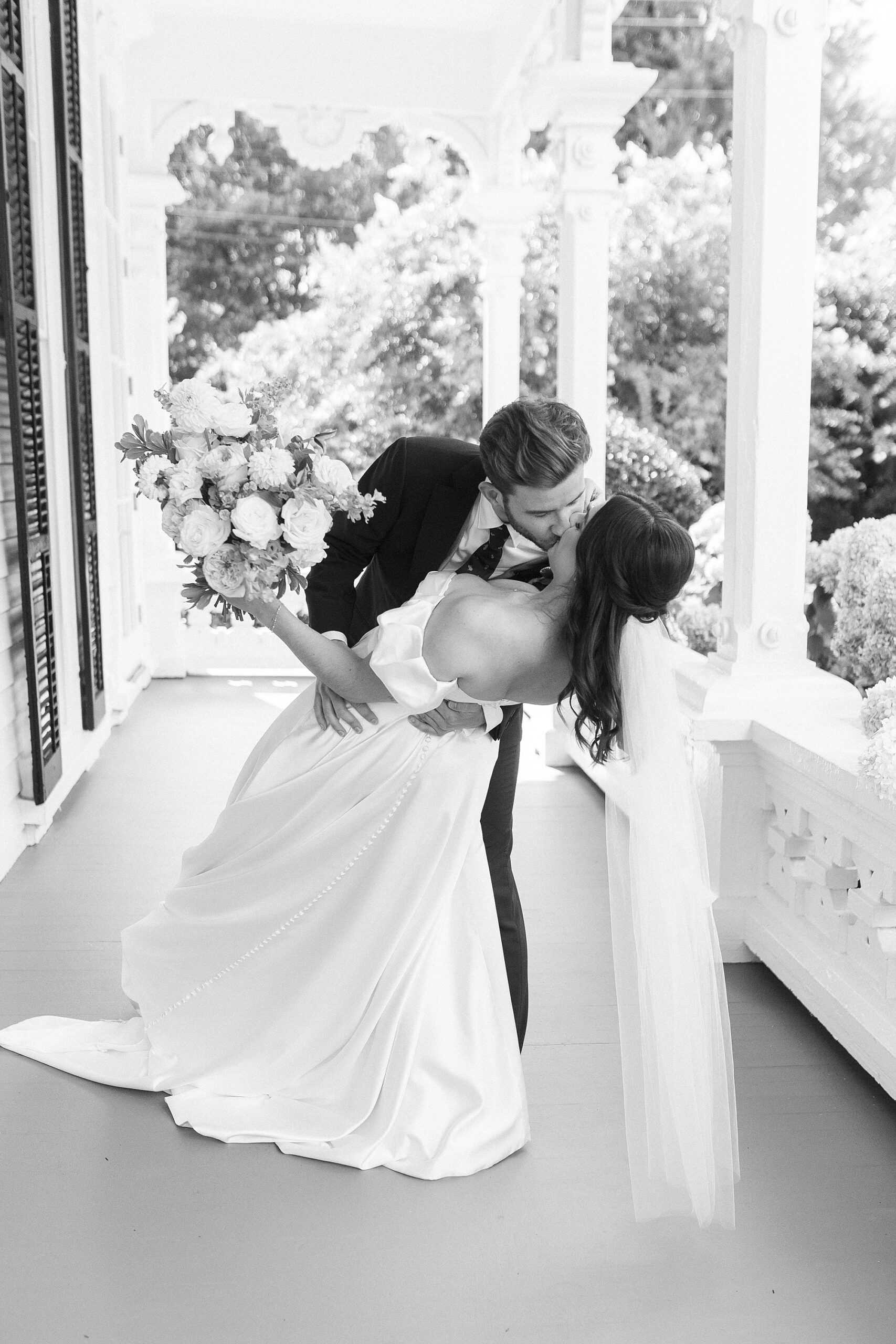 romantic portraits of bride and groom kissing