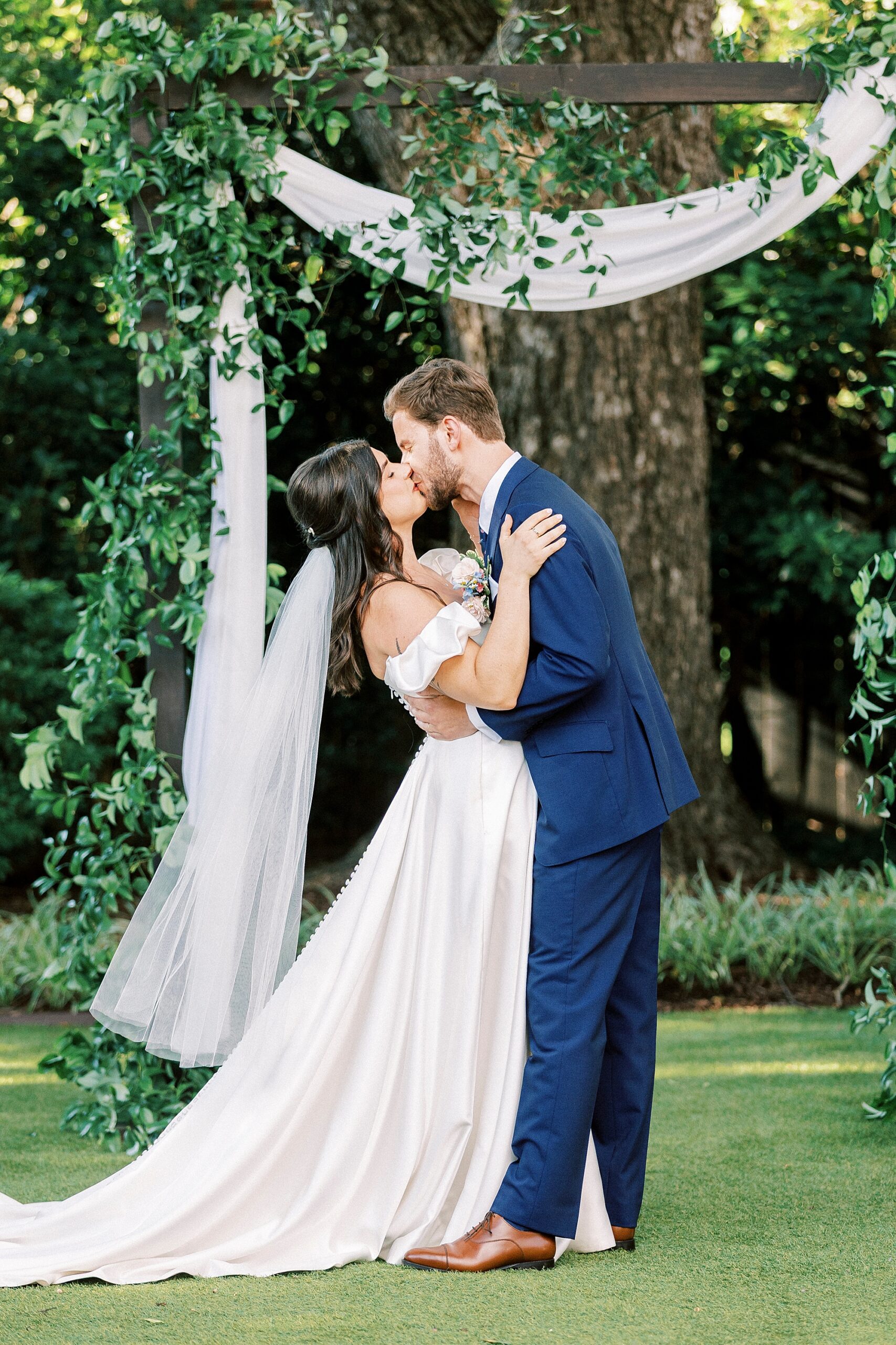 newlyweds kiss at wedding ceremony 