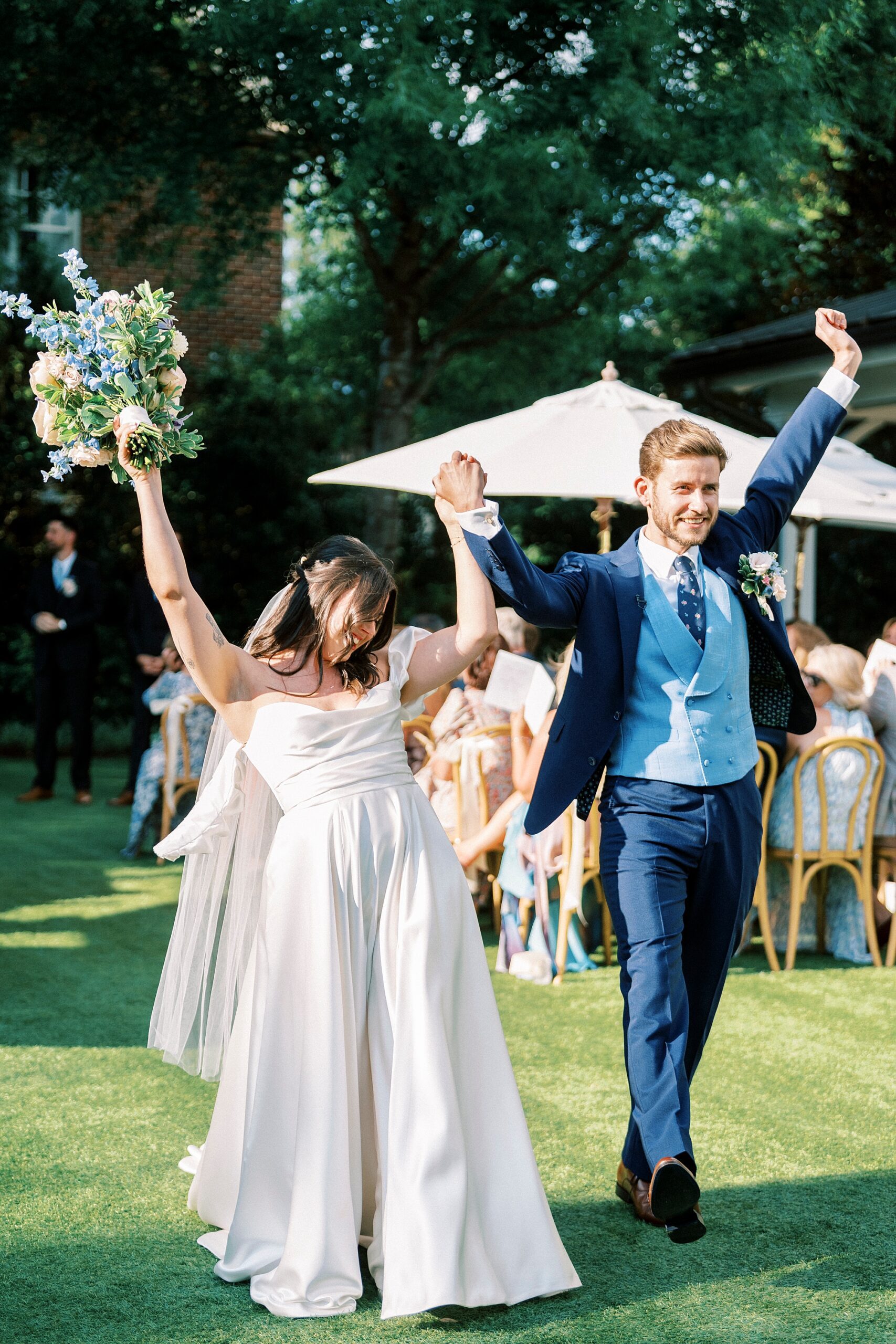 bride and groom celebrate as they exit wedding ceremony 