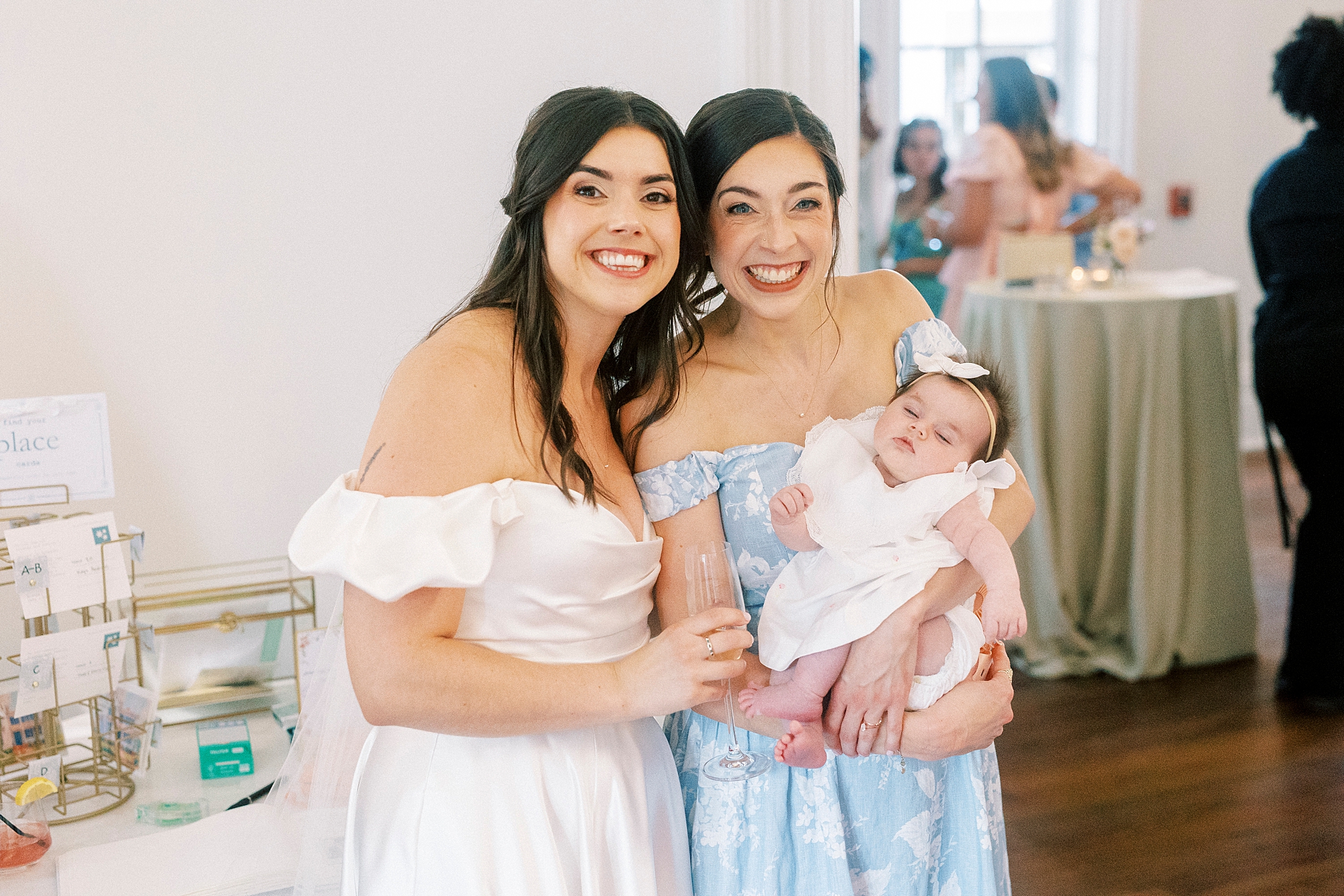 bride with bridesmaid holding baby 