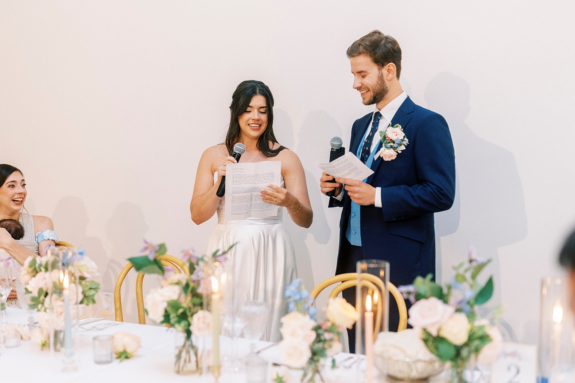 bride and groom deliver speech at reception