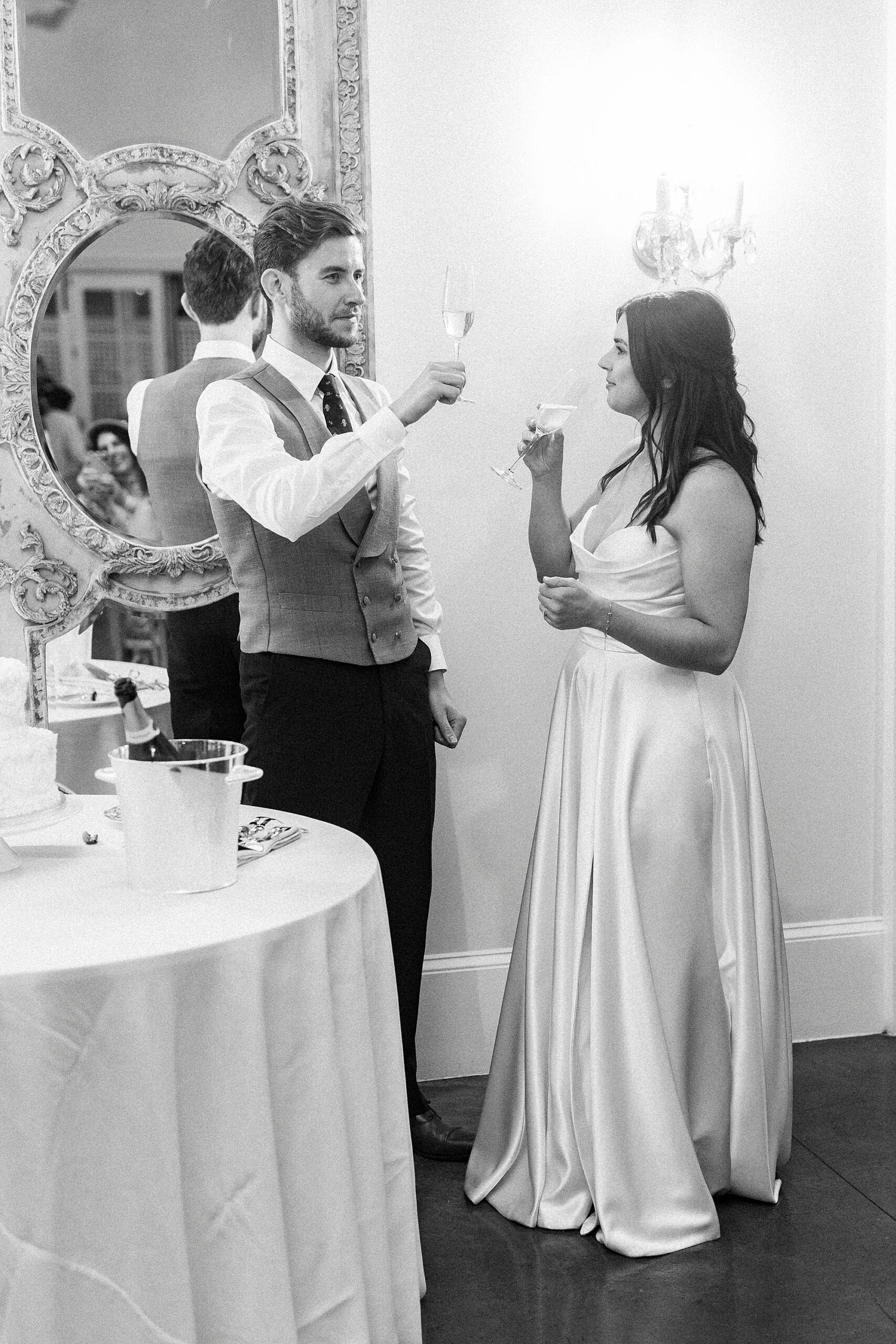 bride and groom share glass of champagne 