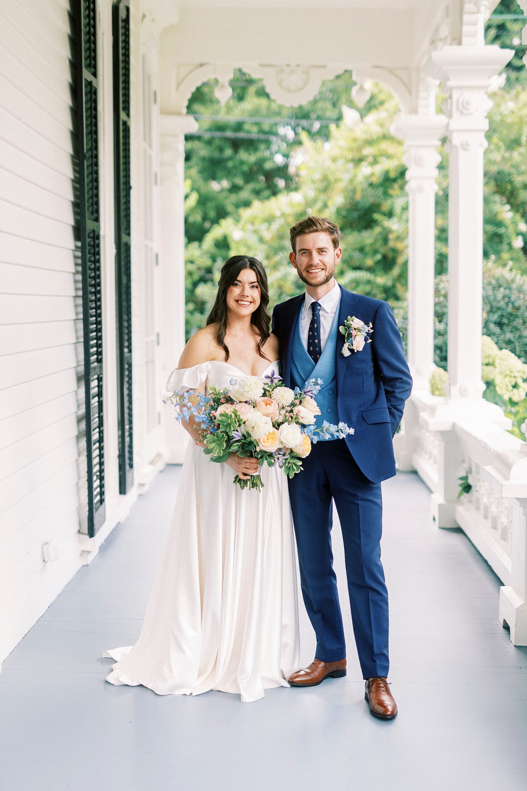 bride and groom on porch of The Merrimon-Wynne House 
