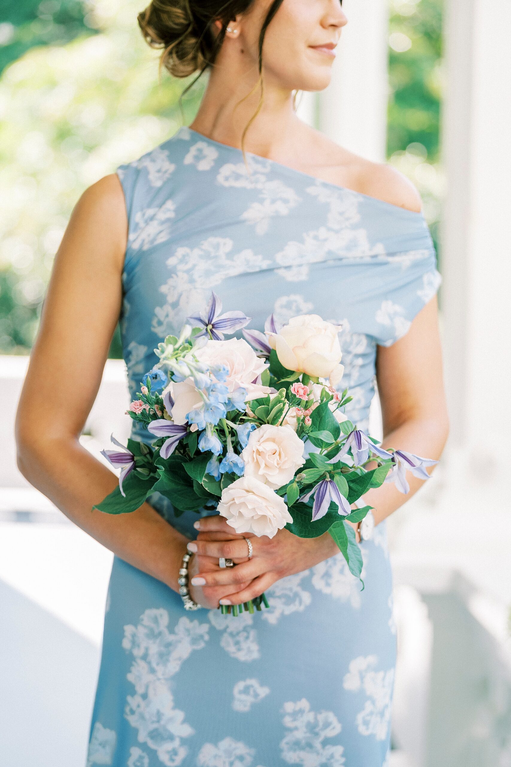 bridesmaids in light blue floral dress and soft bridal bouquets 