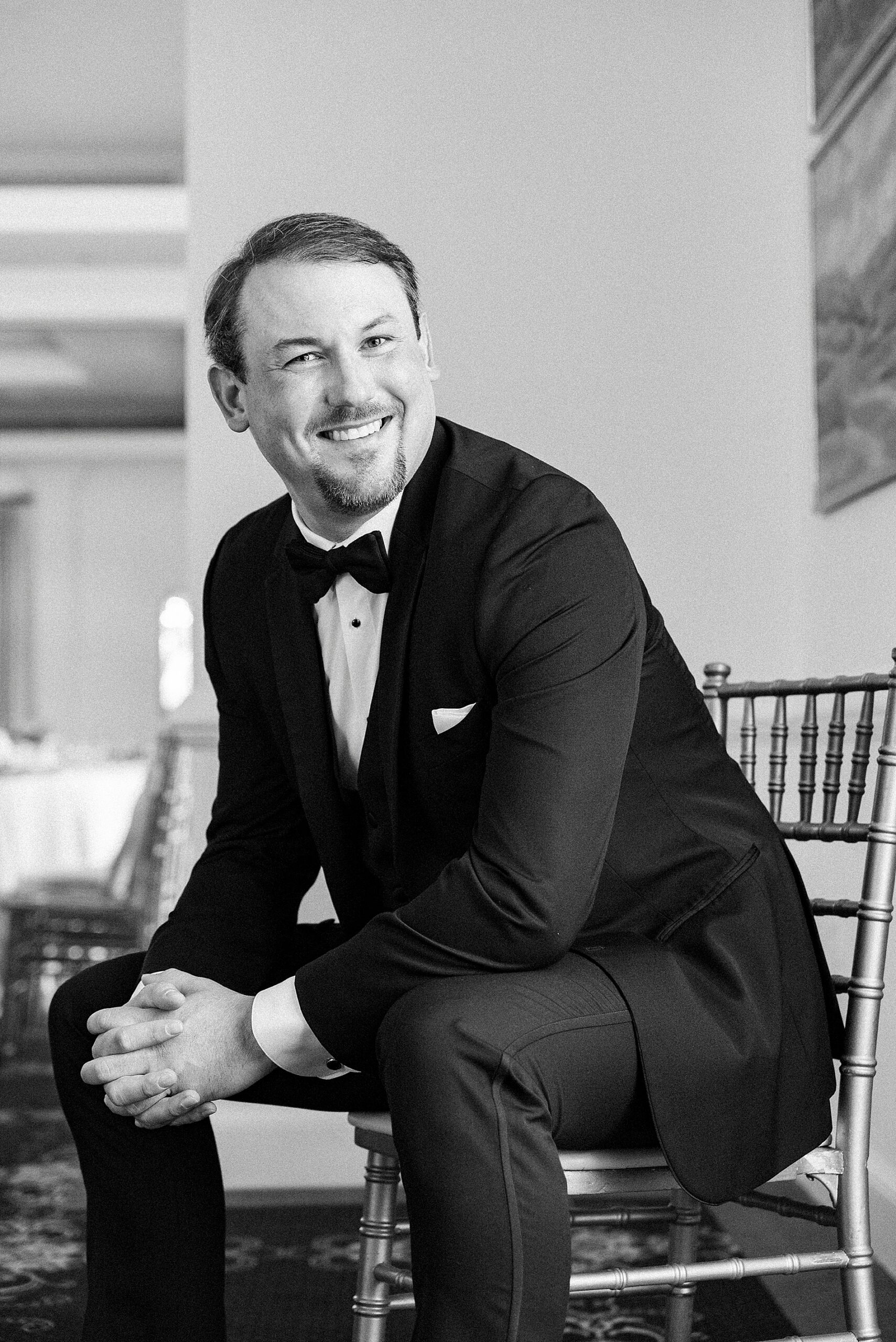 groom sits in chair after getting ready