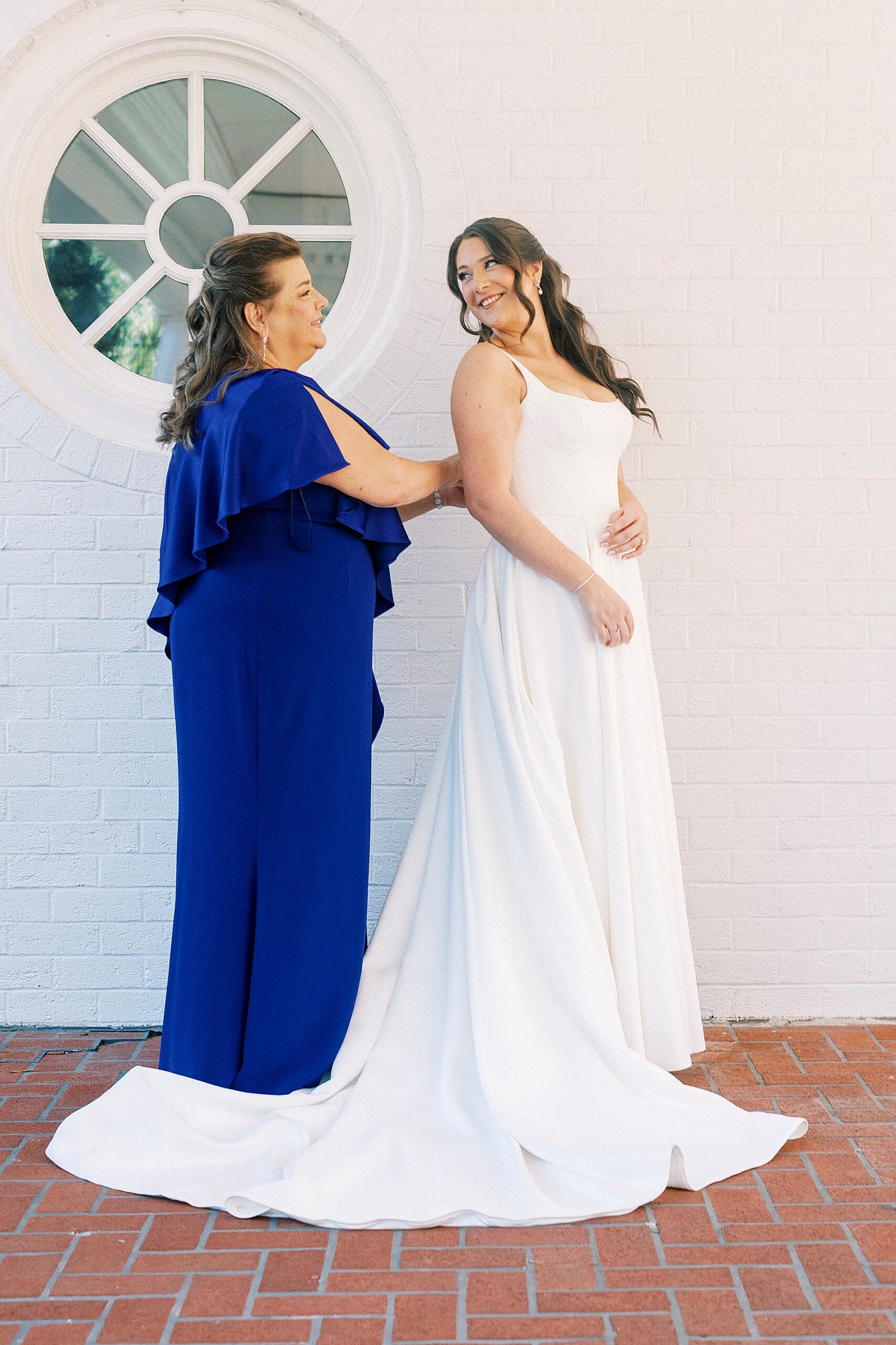 bride getting into wedding dress 