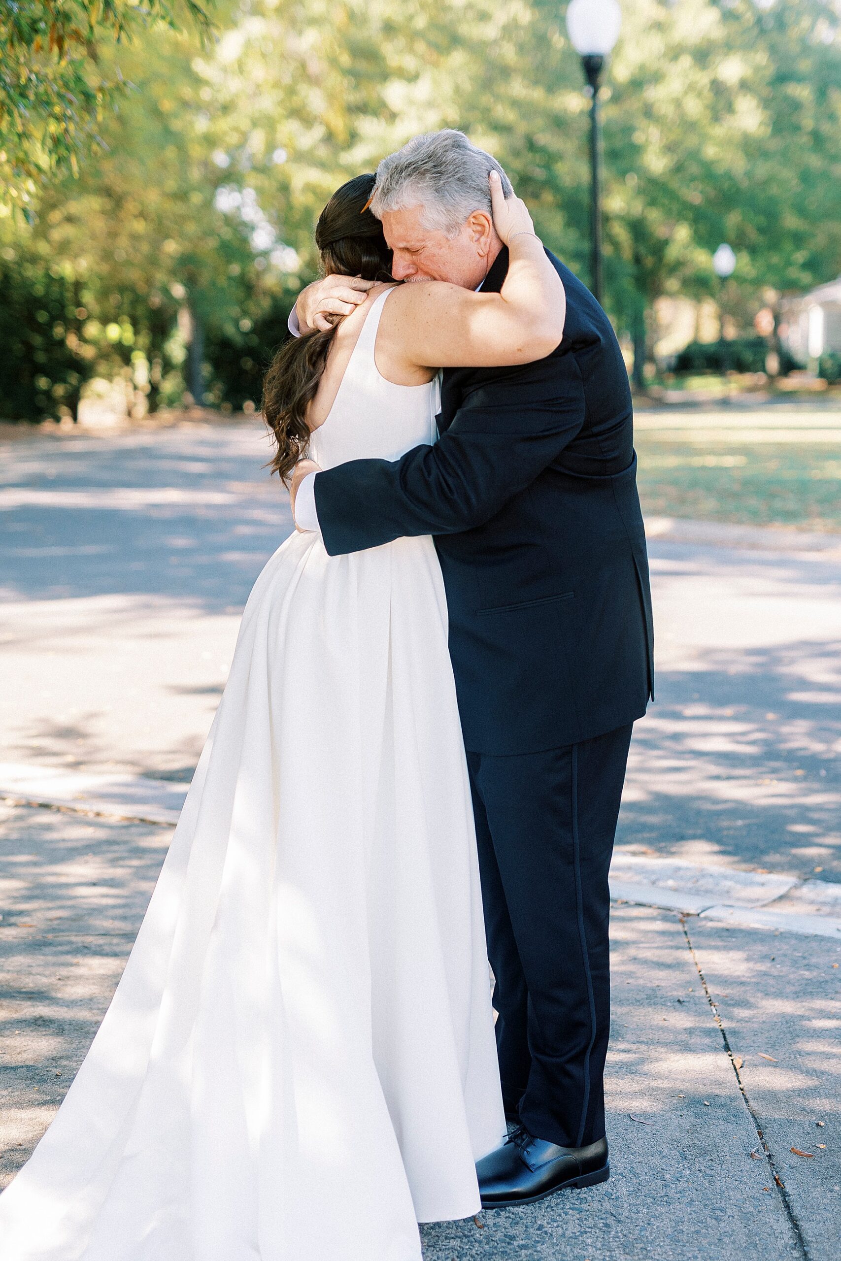 bride hugs dad during first look