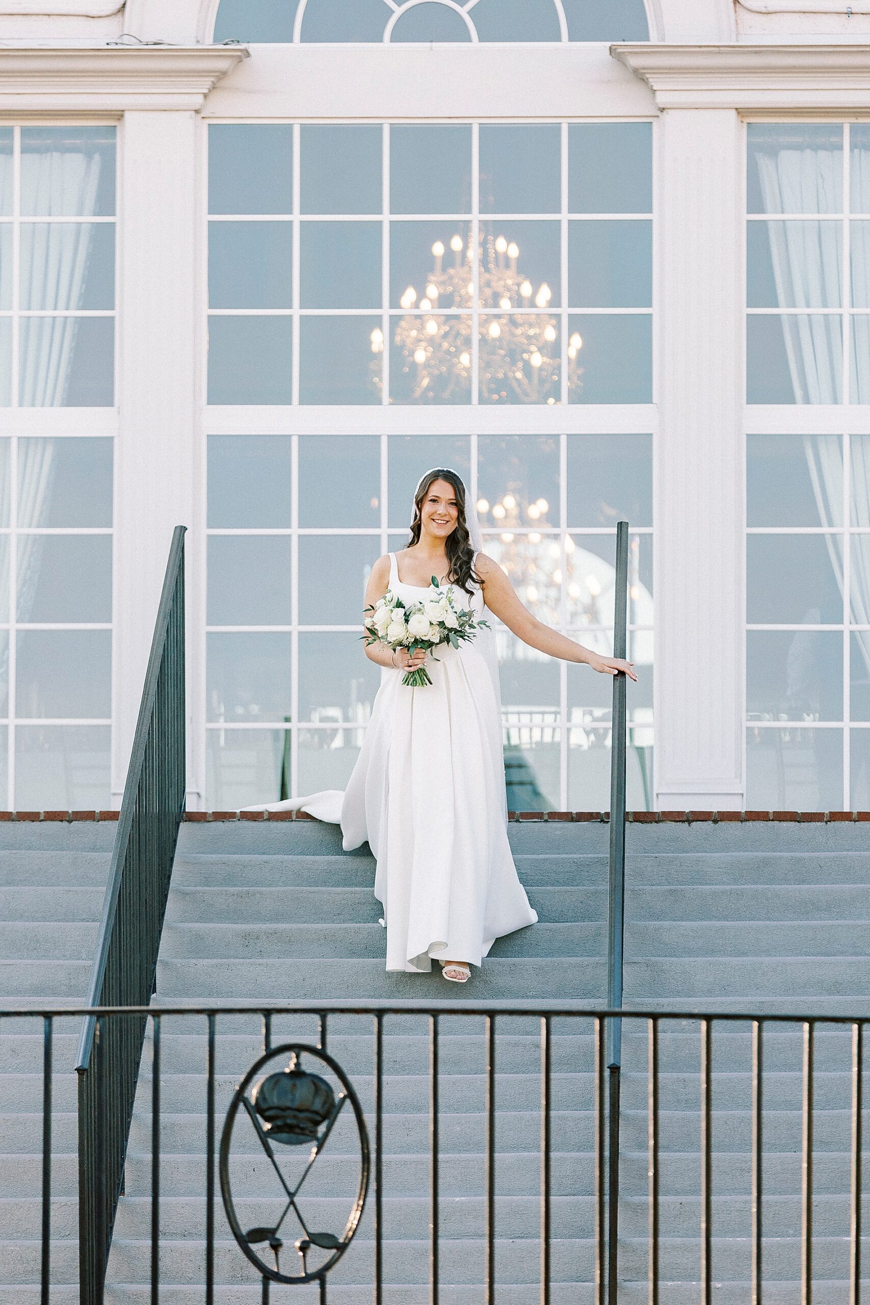 bride walks down staircase to wedding ceremony at Providence Country Club  
