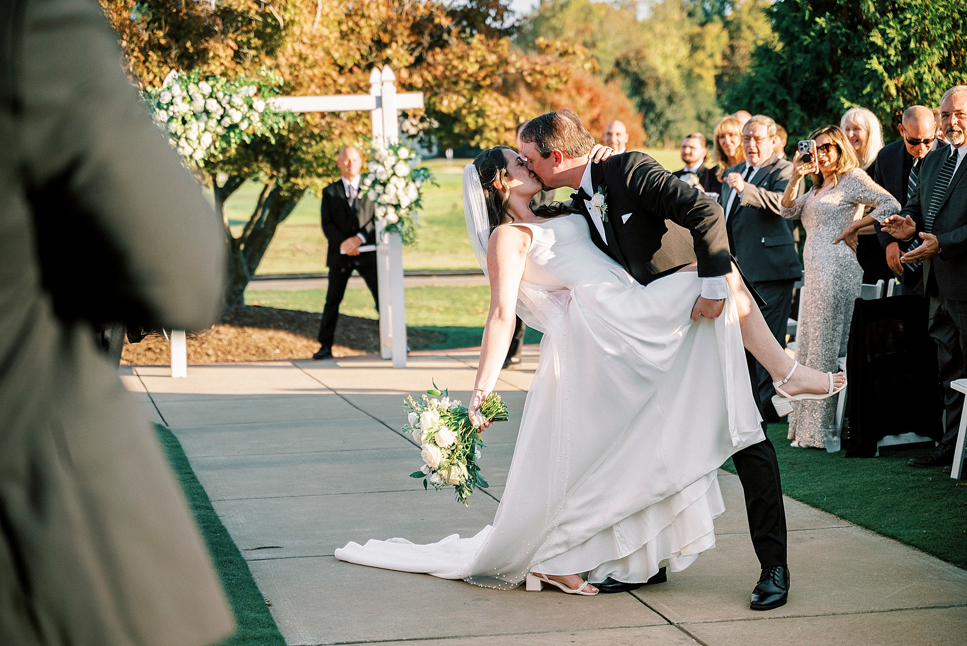 newlyweds kiss as they exit wedding 