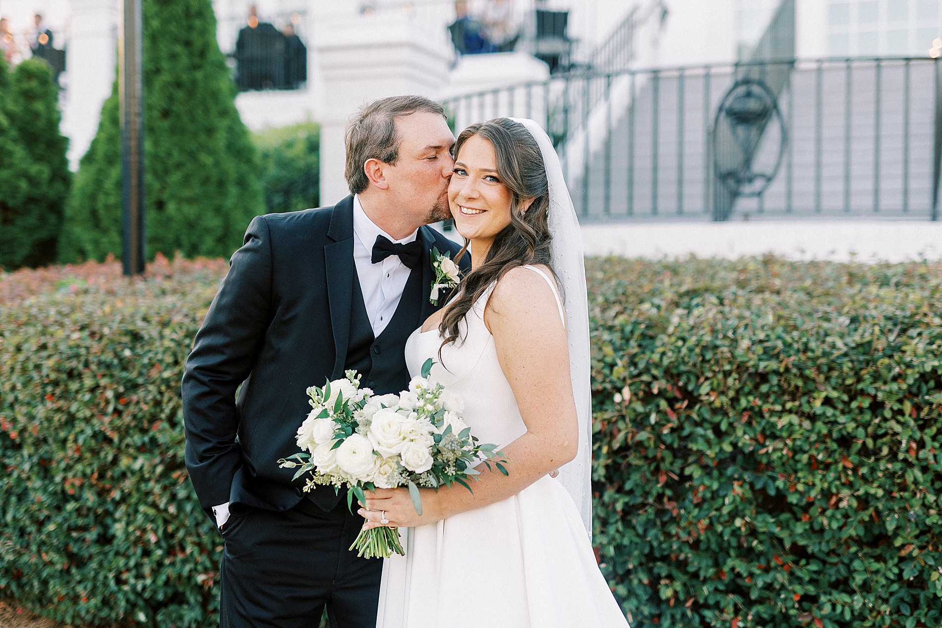 groom kisses bride's cheek