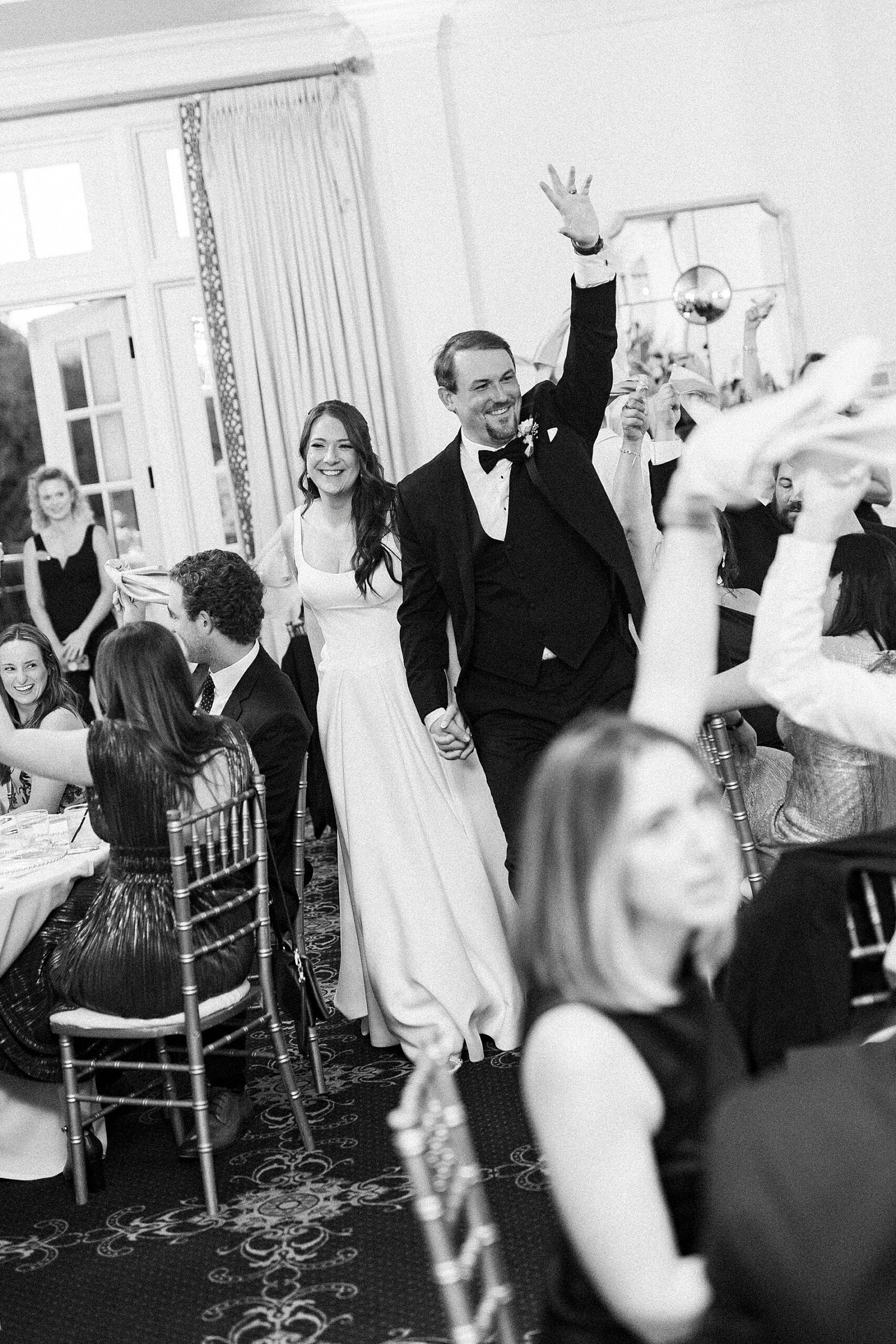 newlyweds enter wedding reception 