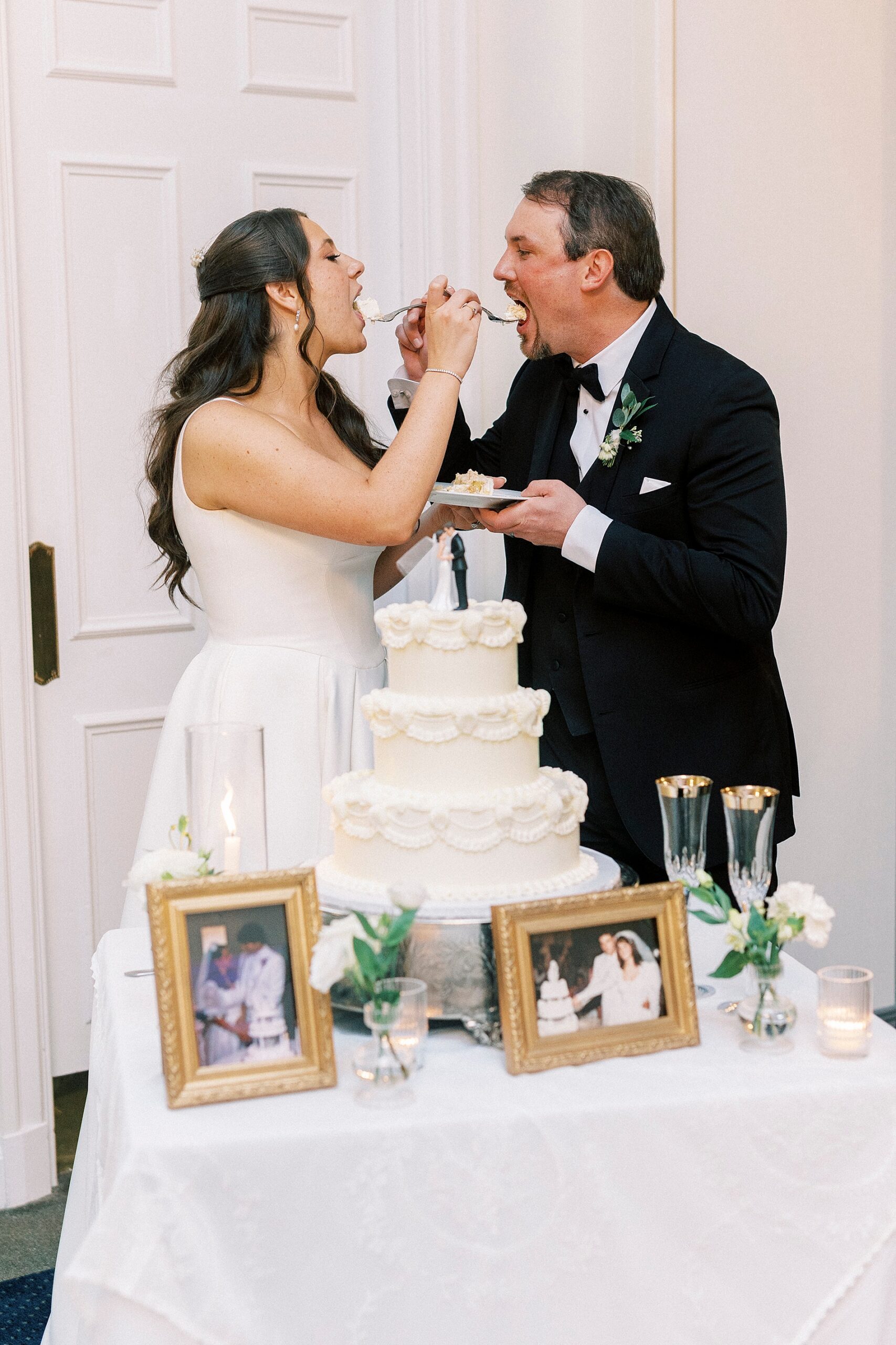 bride and groom feed each other cake
