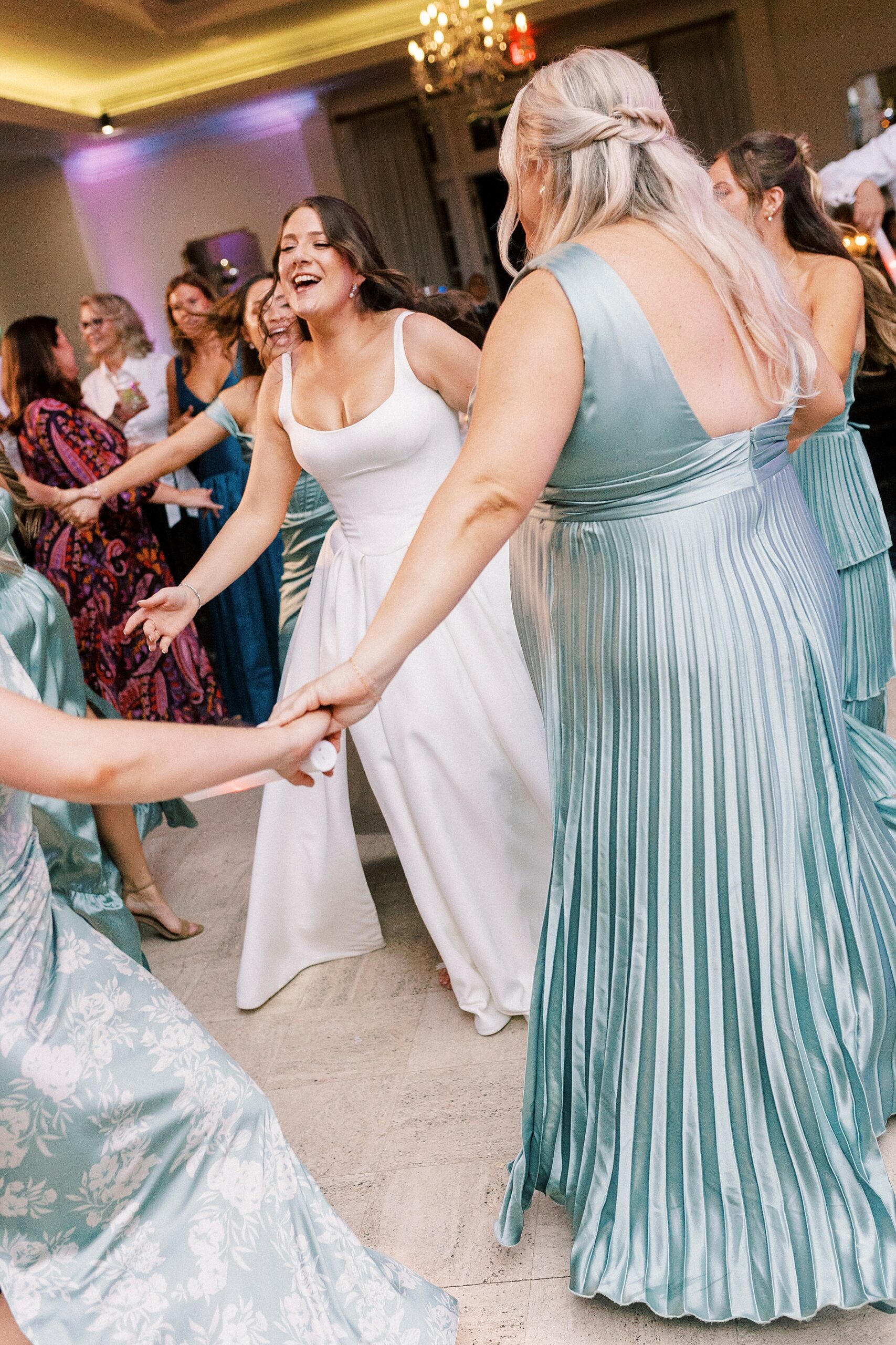 bride and bridesmaids on dance floor 