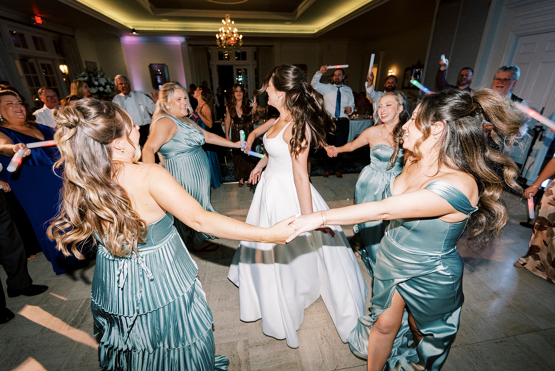 bridesmaids circle bride on dance floor 