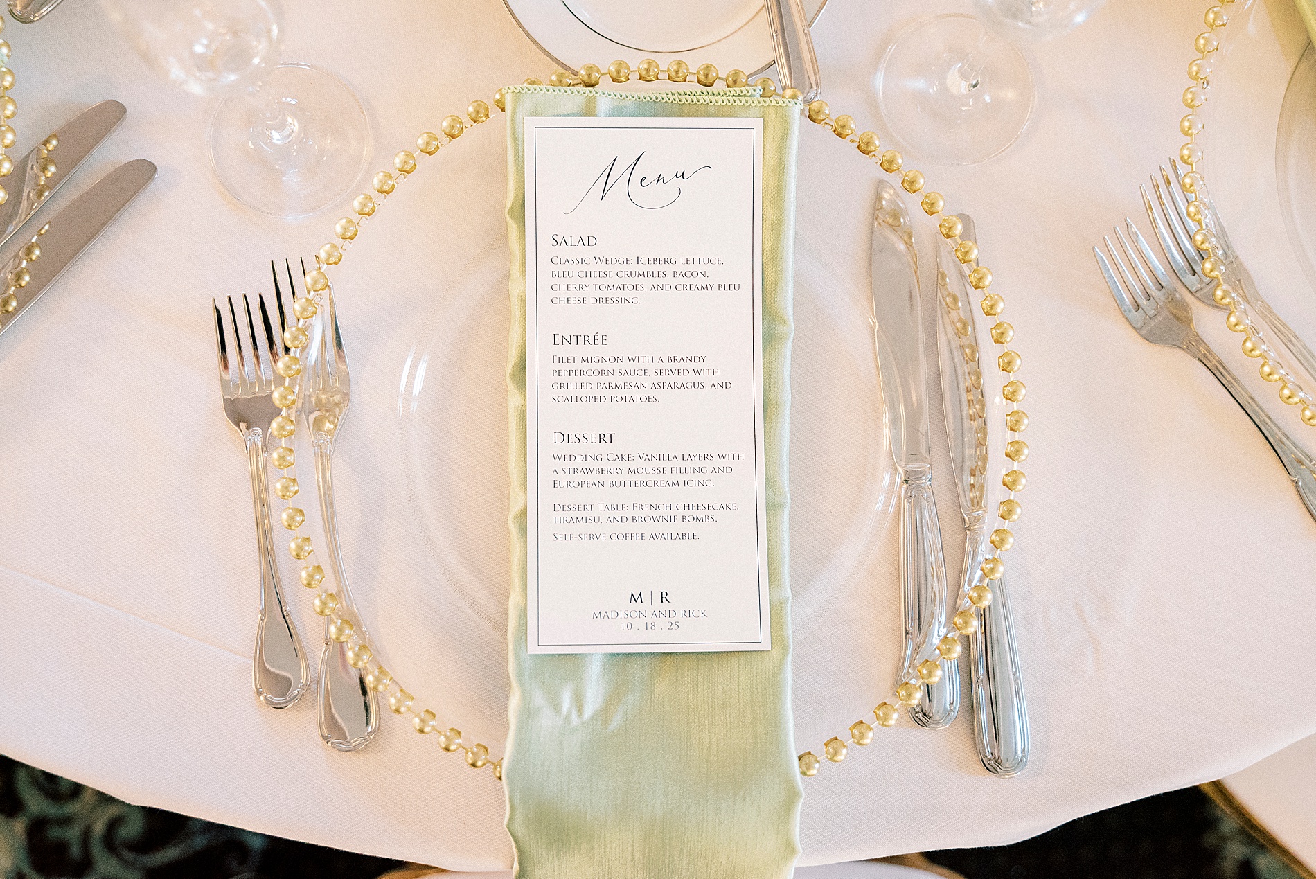 wedding place setting with menus on light green napkins