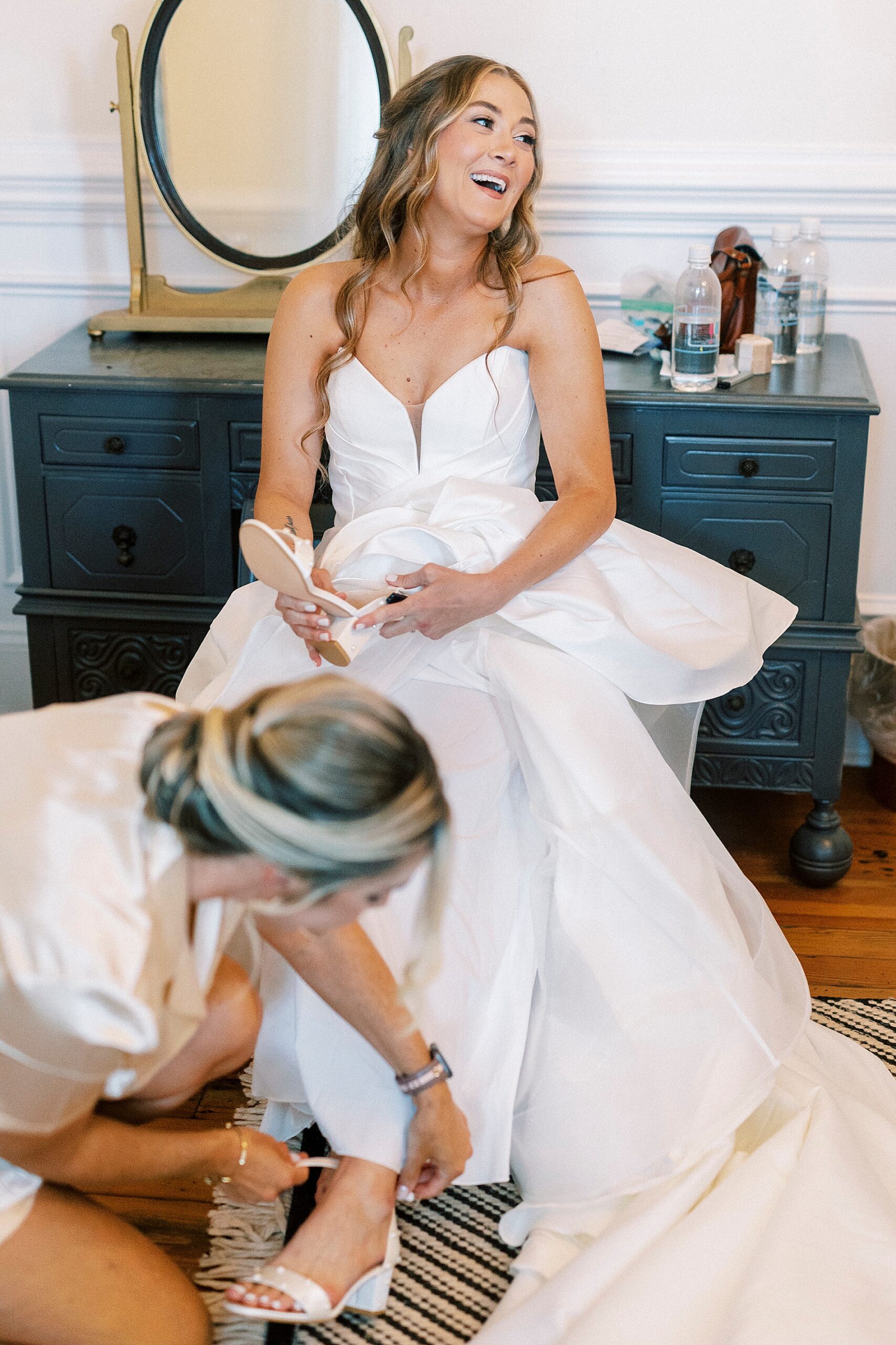 bride getting shoes on