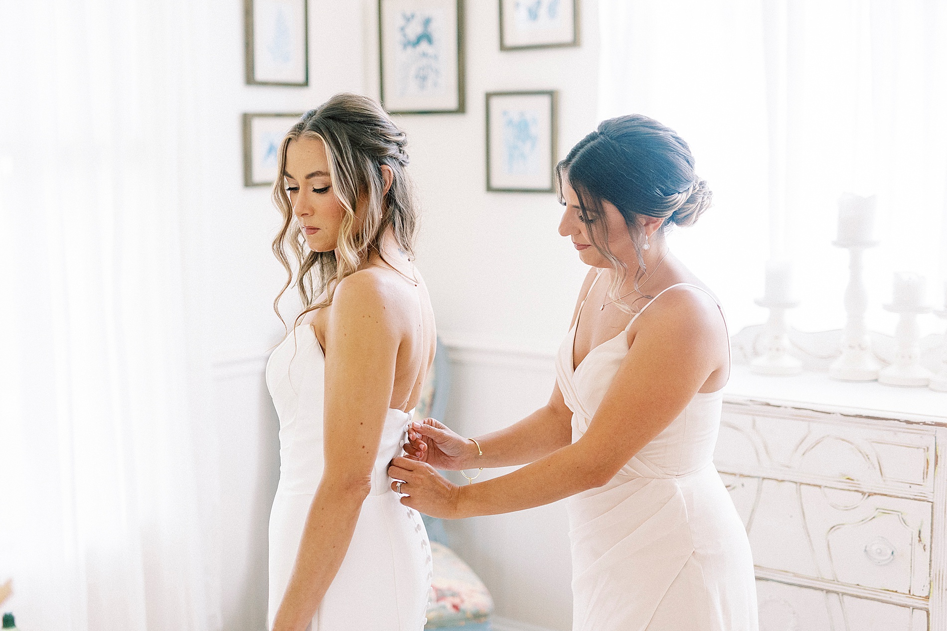 bride getting into wedding dress