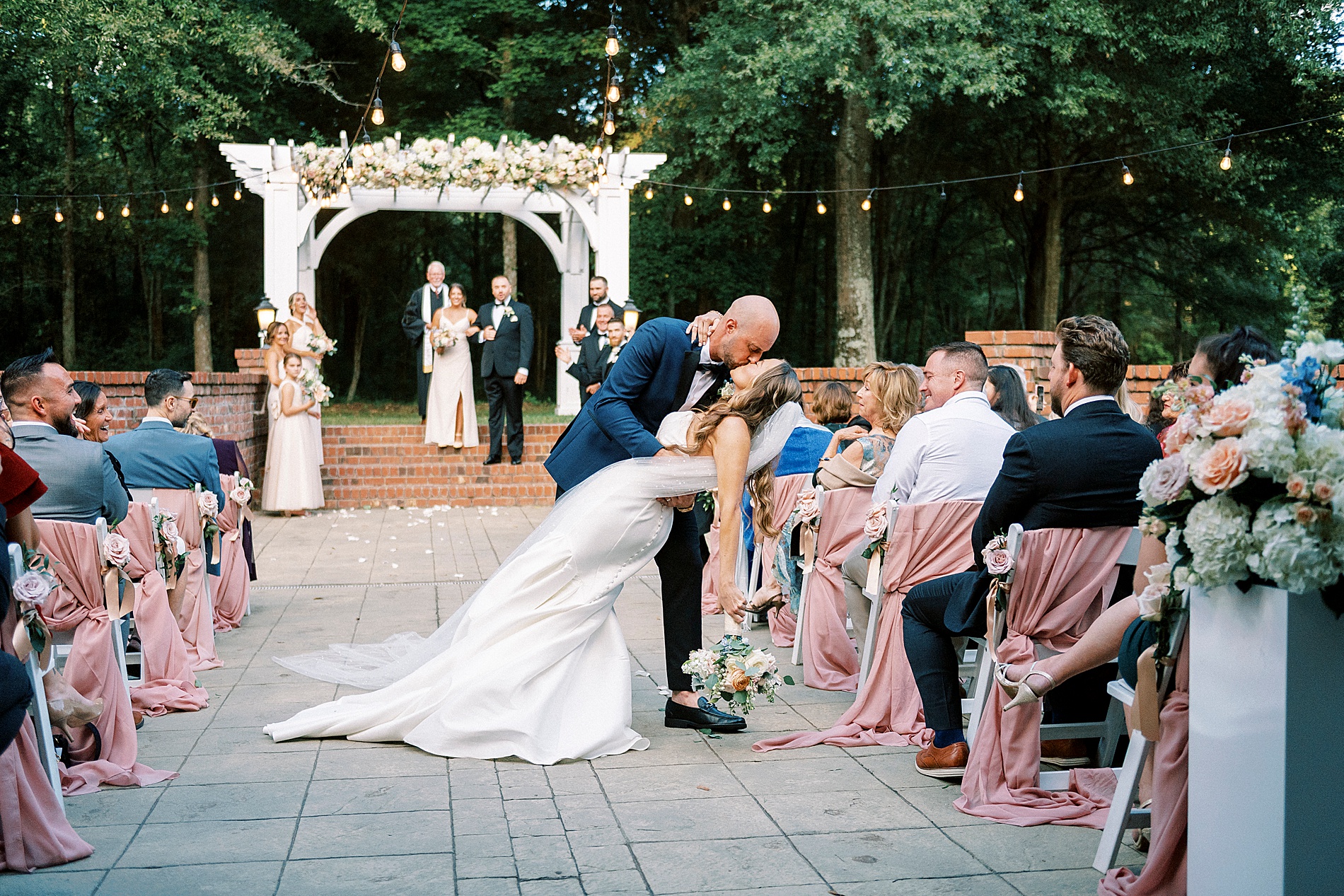 groom dips bride as they kiss
