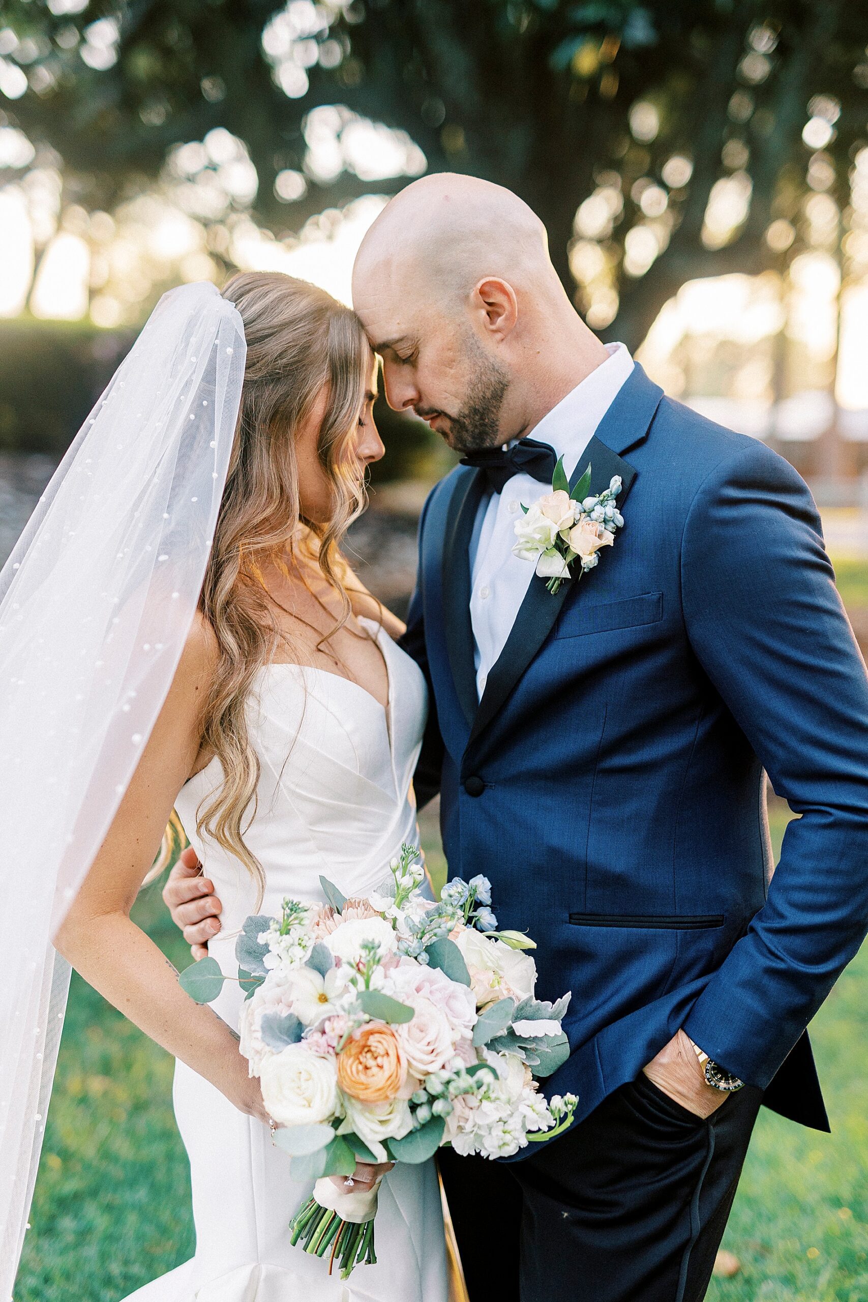 newlyweds lean their heads in towards each other