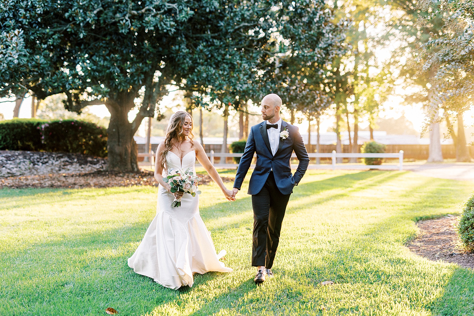 bride and groom walk together holding hands