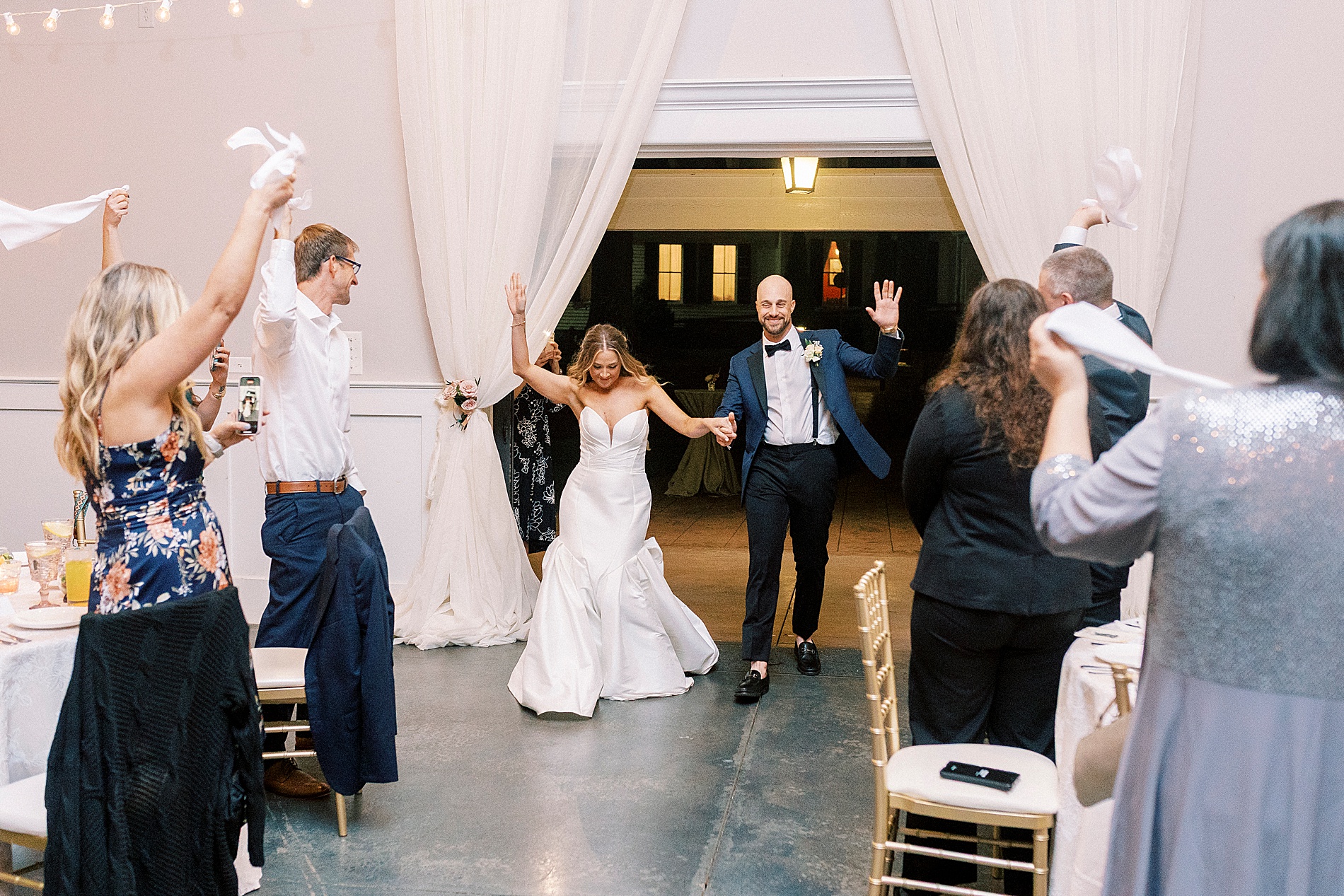 newlyweds enter wedding reception