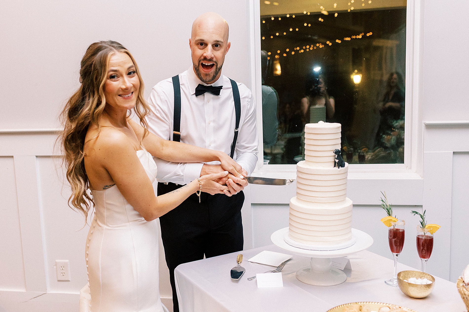 bride and groom cut wedding cake