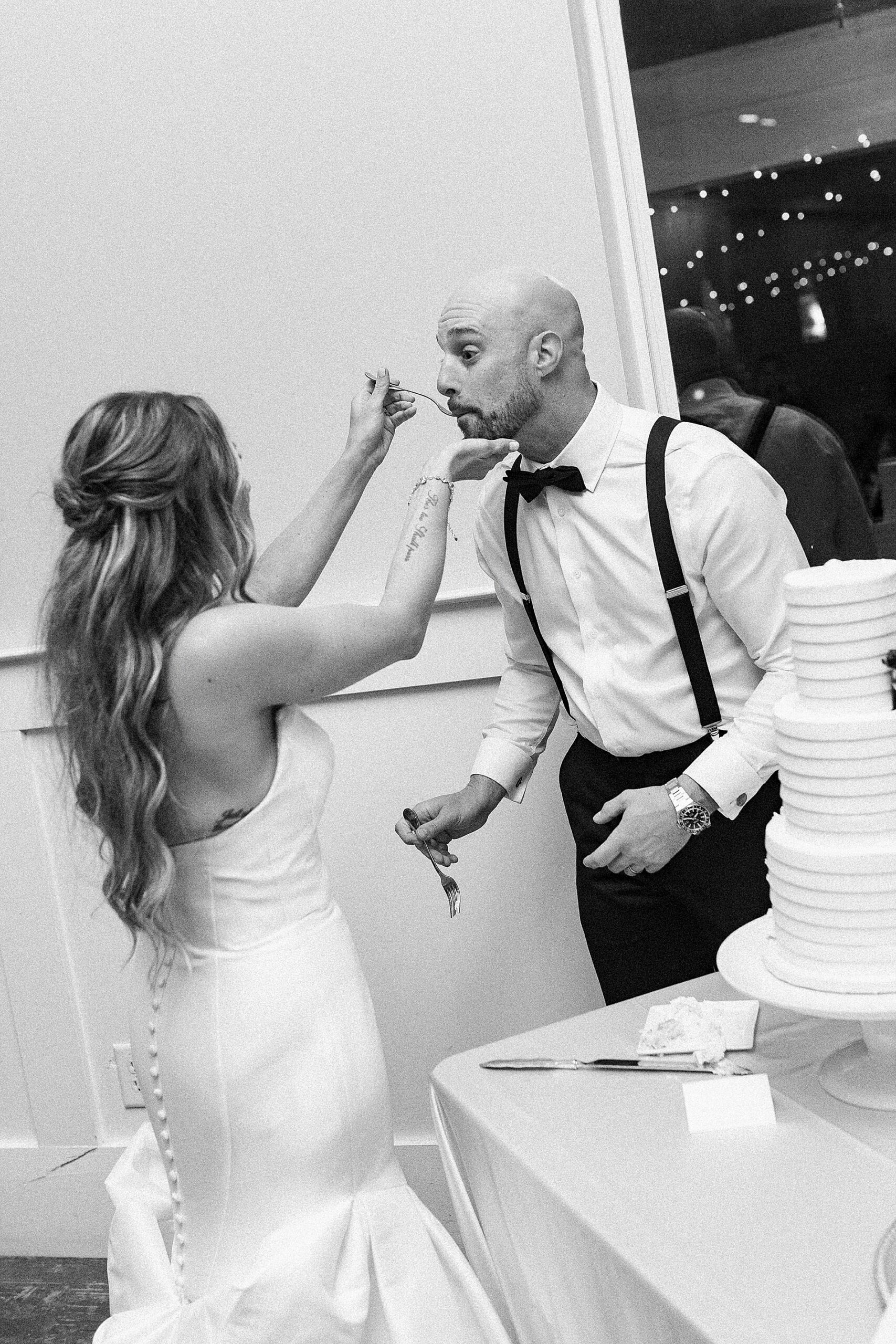 bride feeds cake to groom