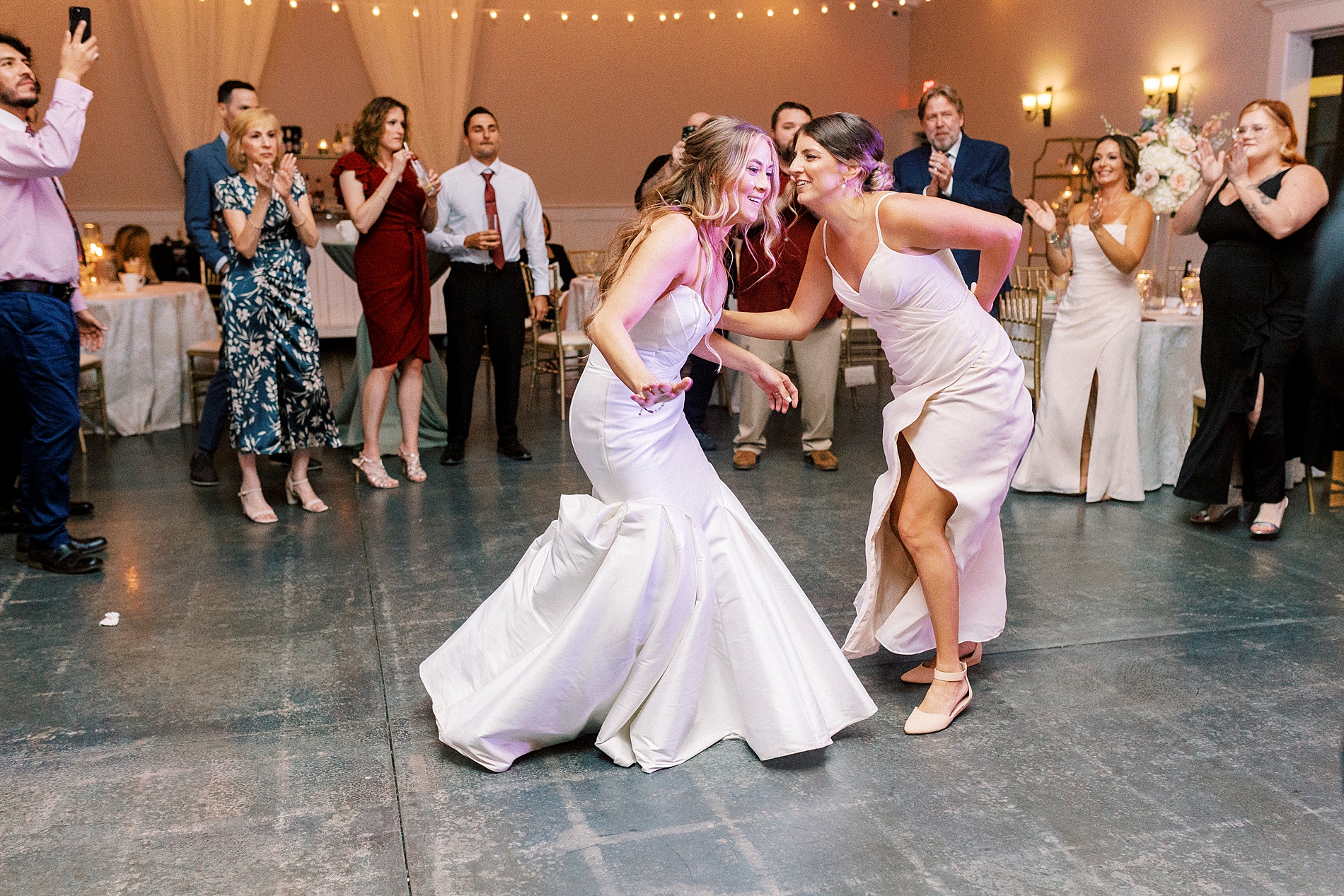 bride and bridesmaid on dance floor