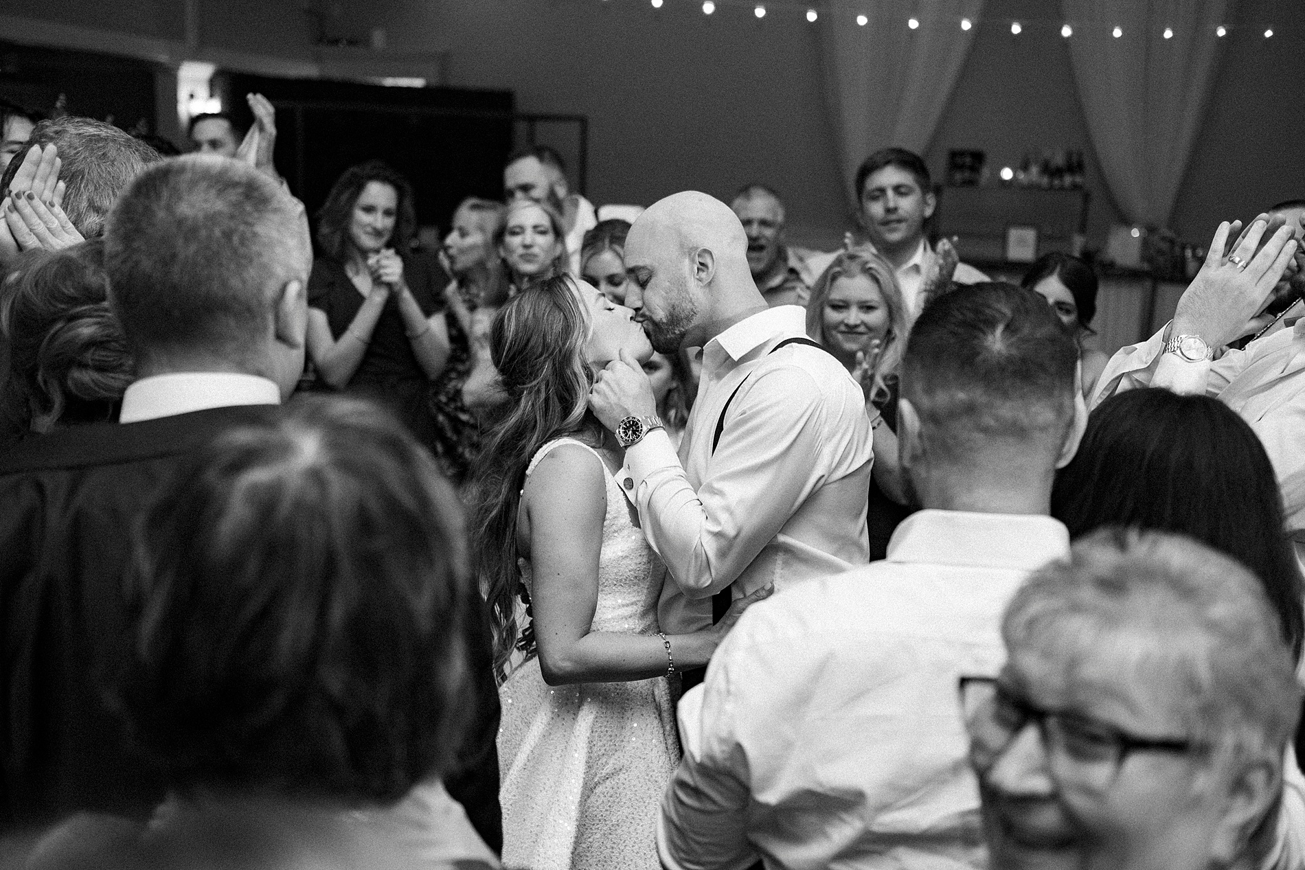 bride and groom kiss on dance floor