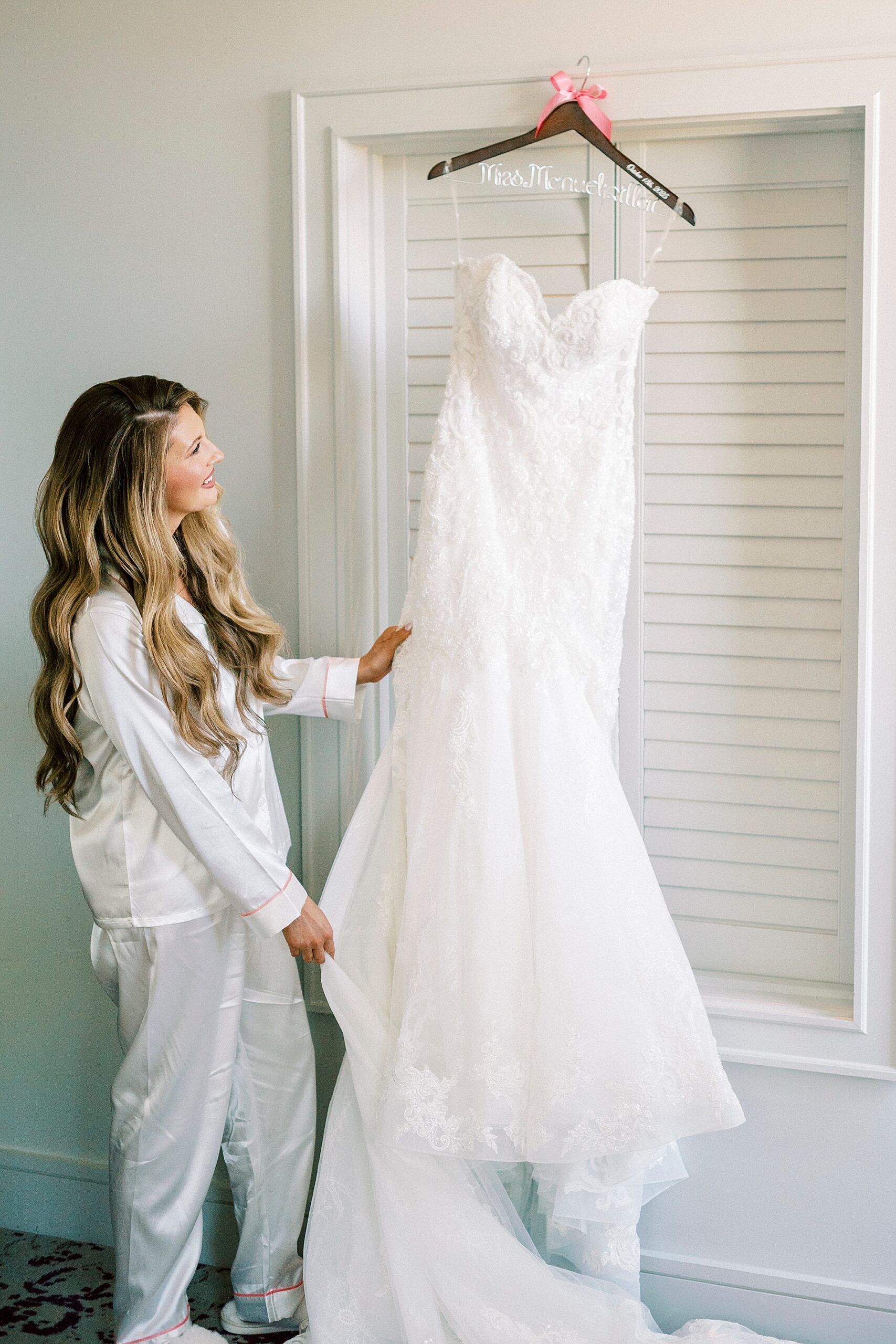 bride looks at wedding dress 