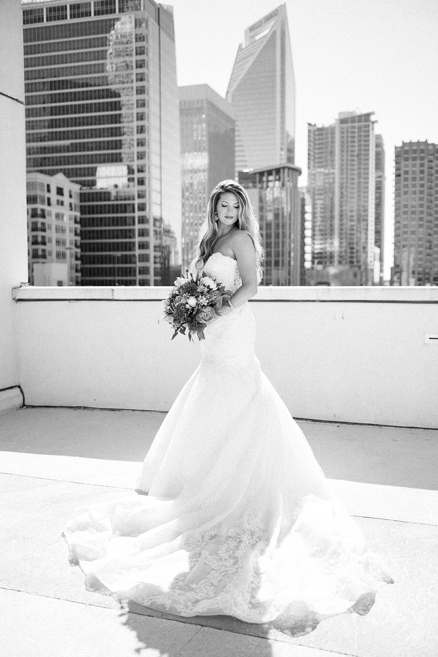 bridal portraits on rooftop of The Grand Bohemian Hotel Wedding with skyline of Charlotte in the background  
