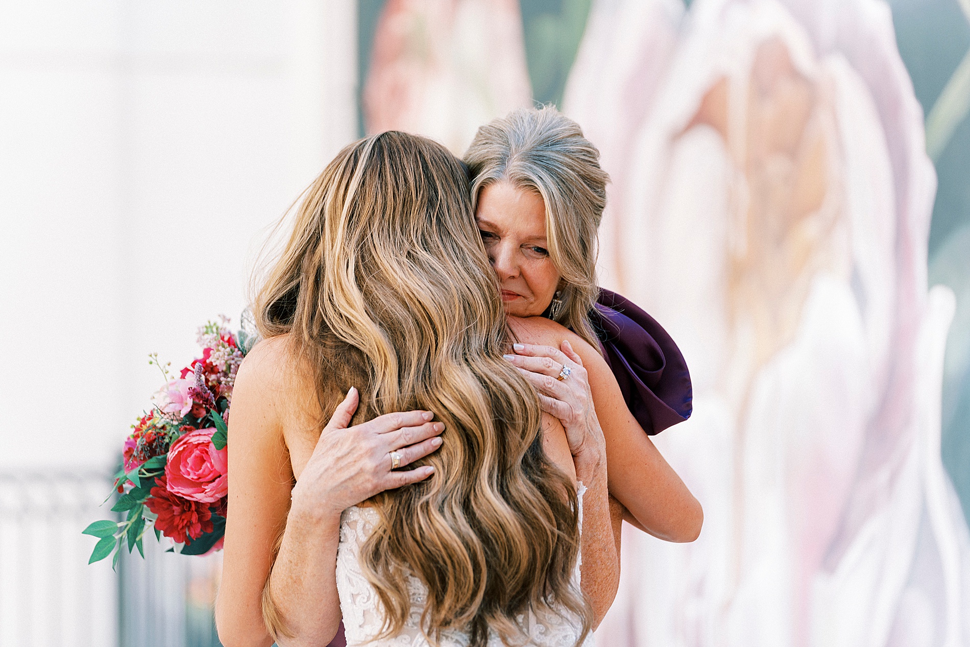 mom hugs bride during first look 