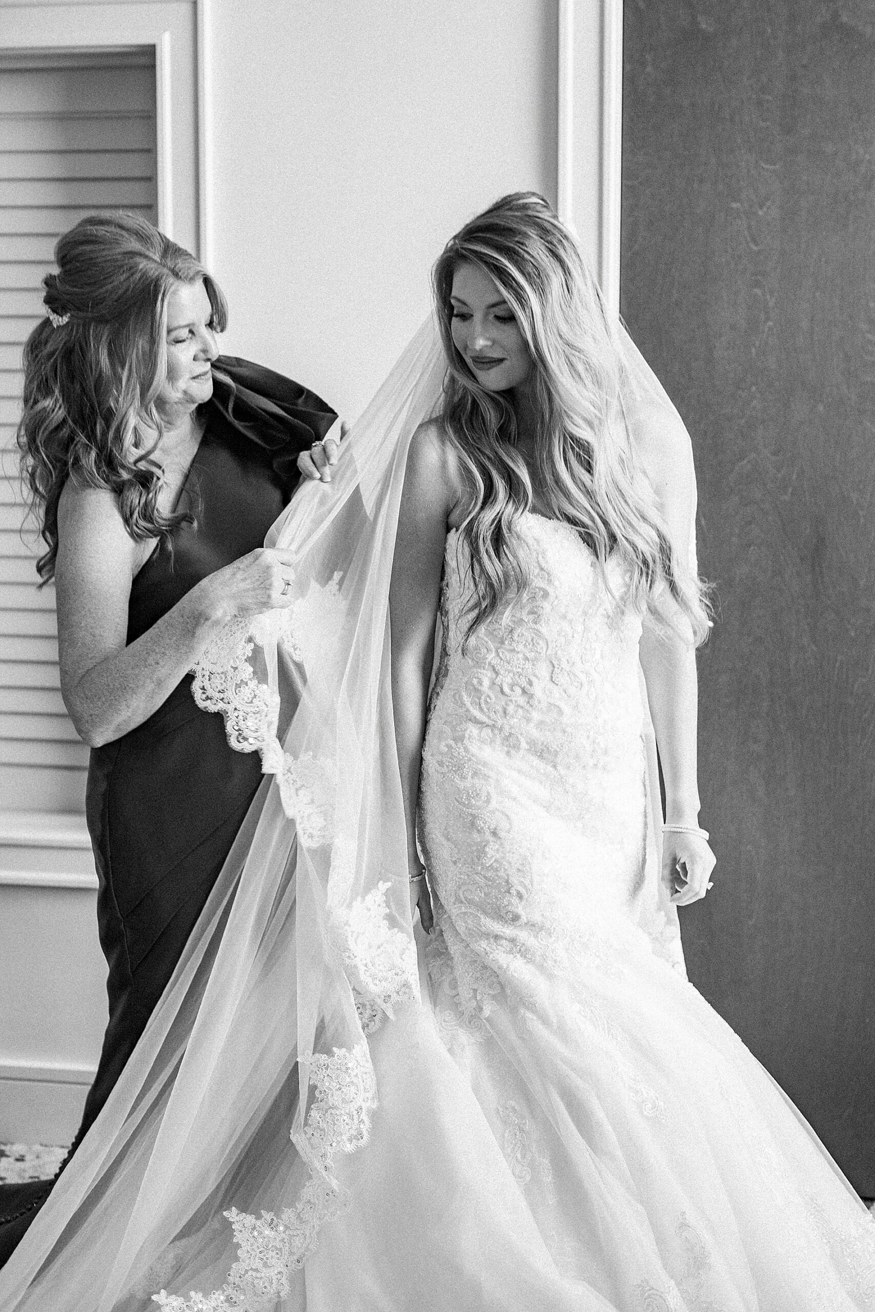 mom helps bride with veil