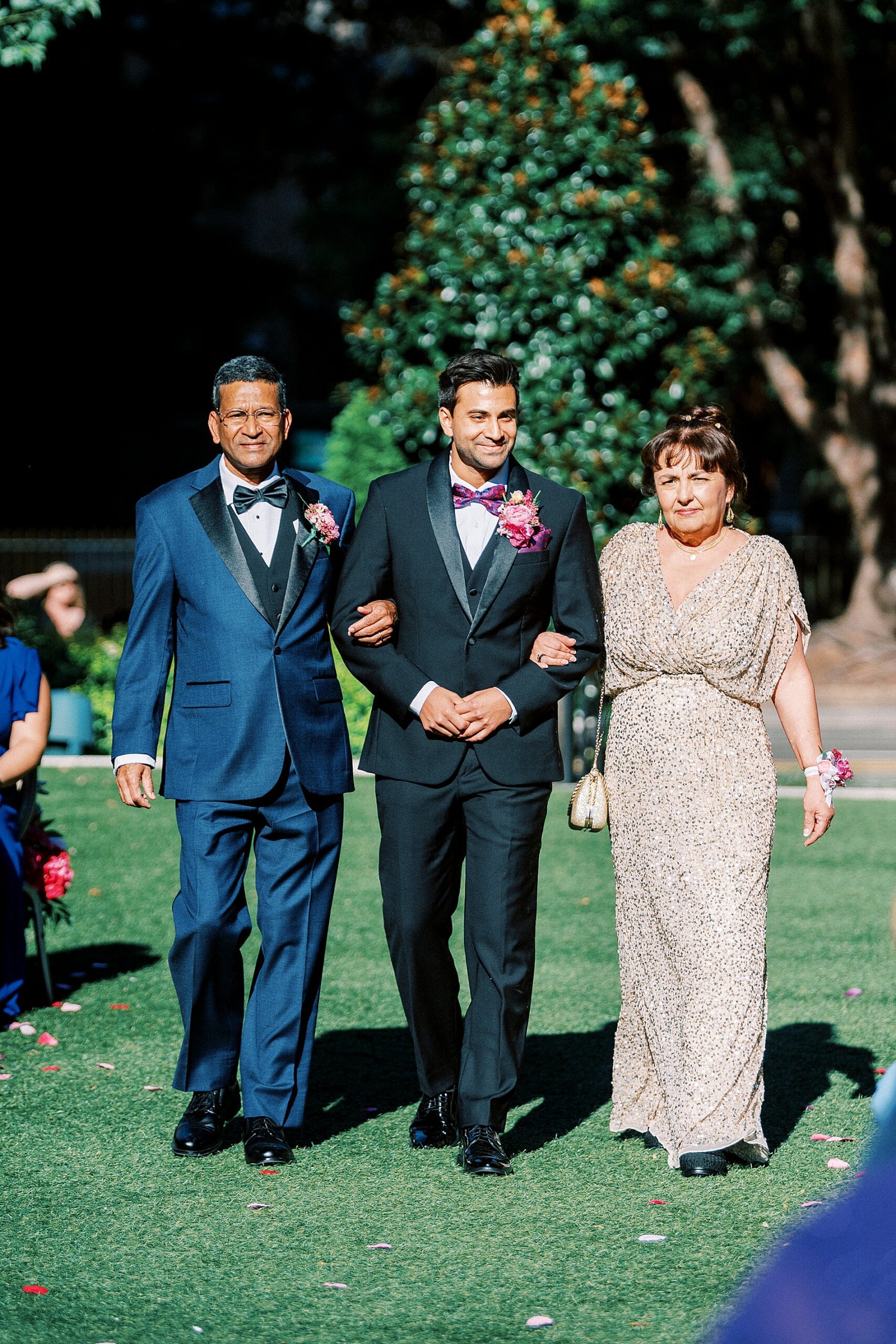 parents walk groom down the aisle  