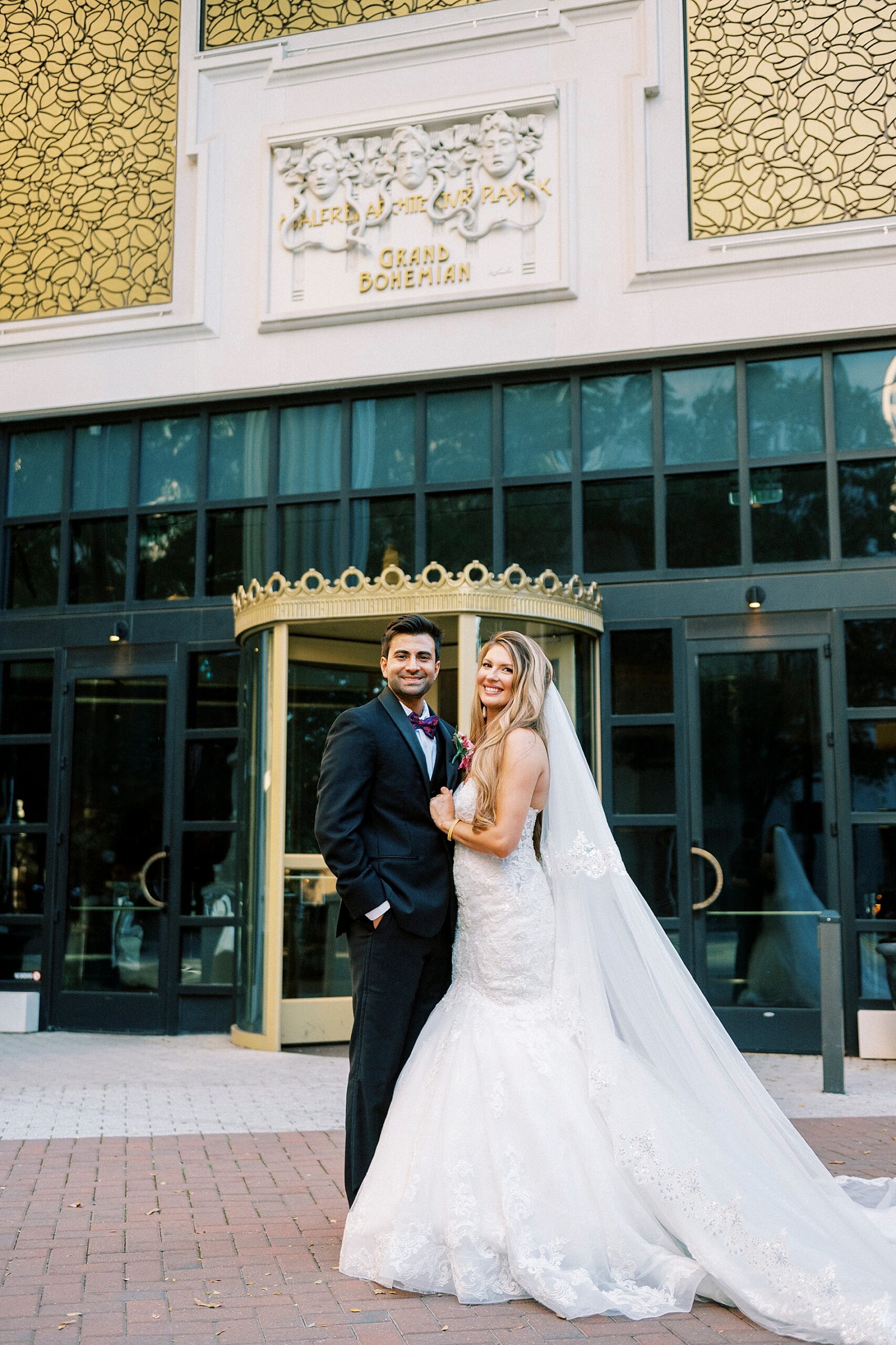 newlyweds stand outside The Grand Bohemian Hotel in Uptown Charlotte, NC