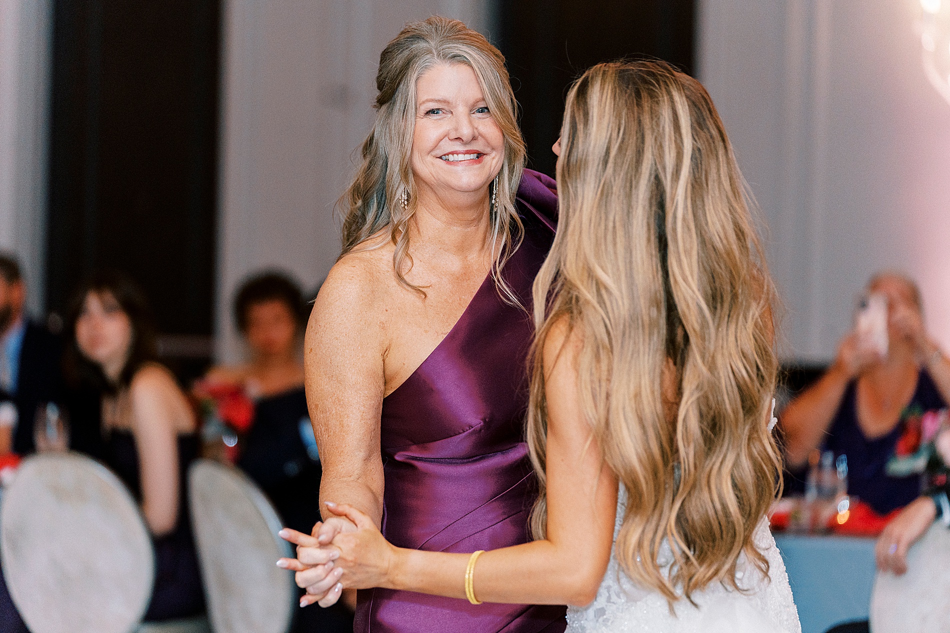 bride dances with mom at wedding reception 