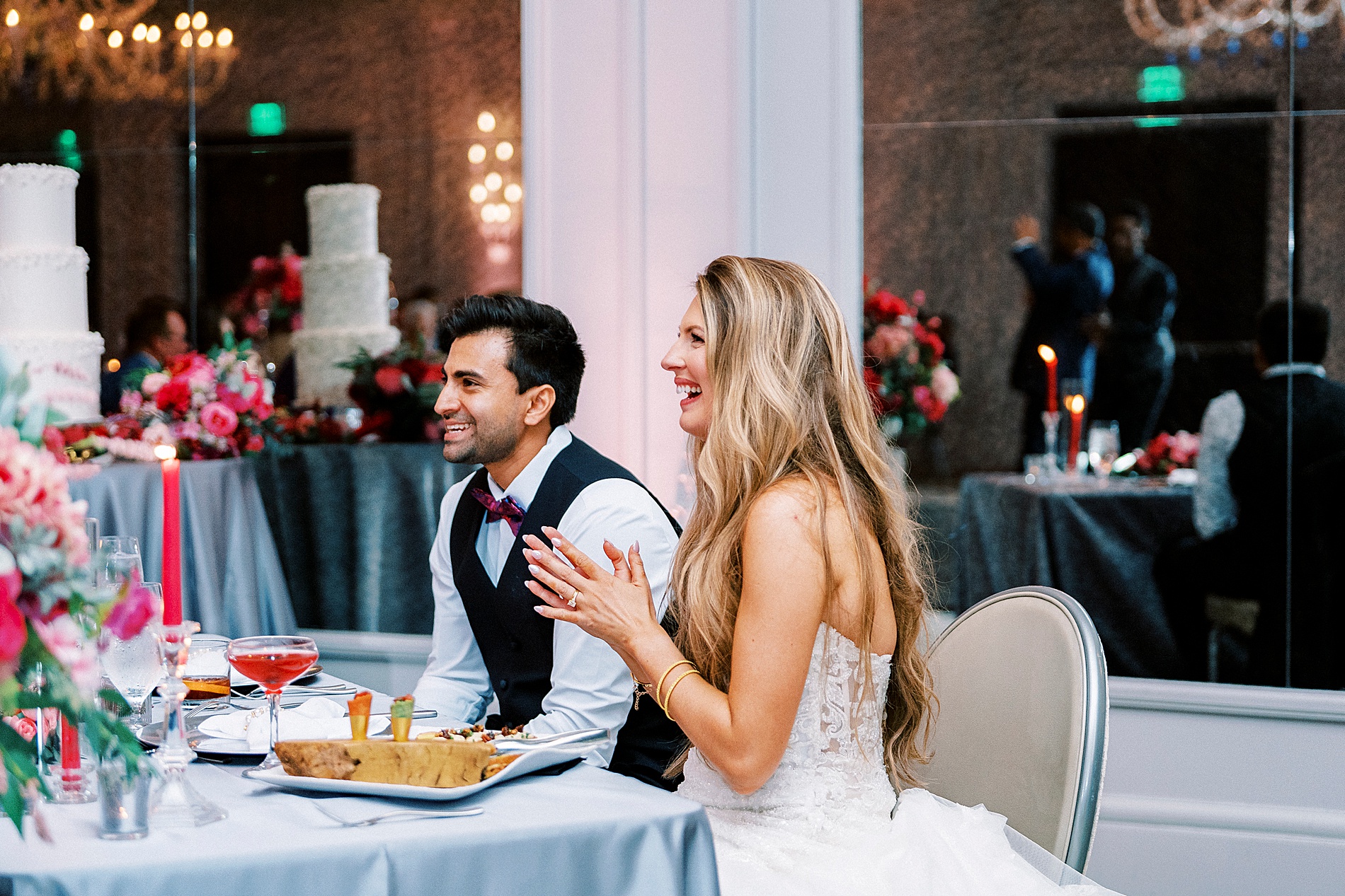 newlyweds listen to wedding toasts 
