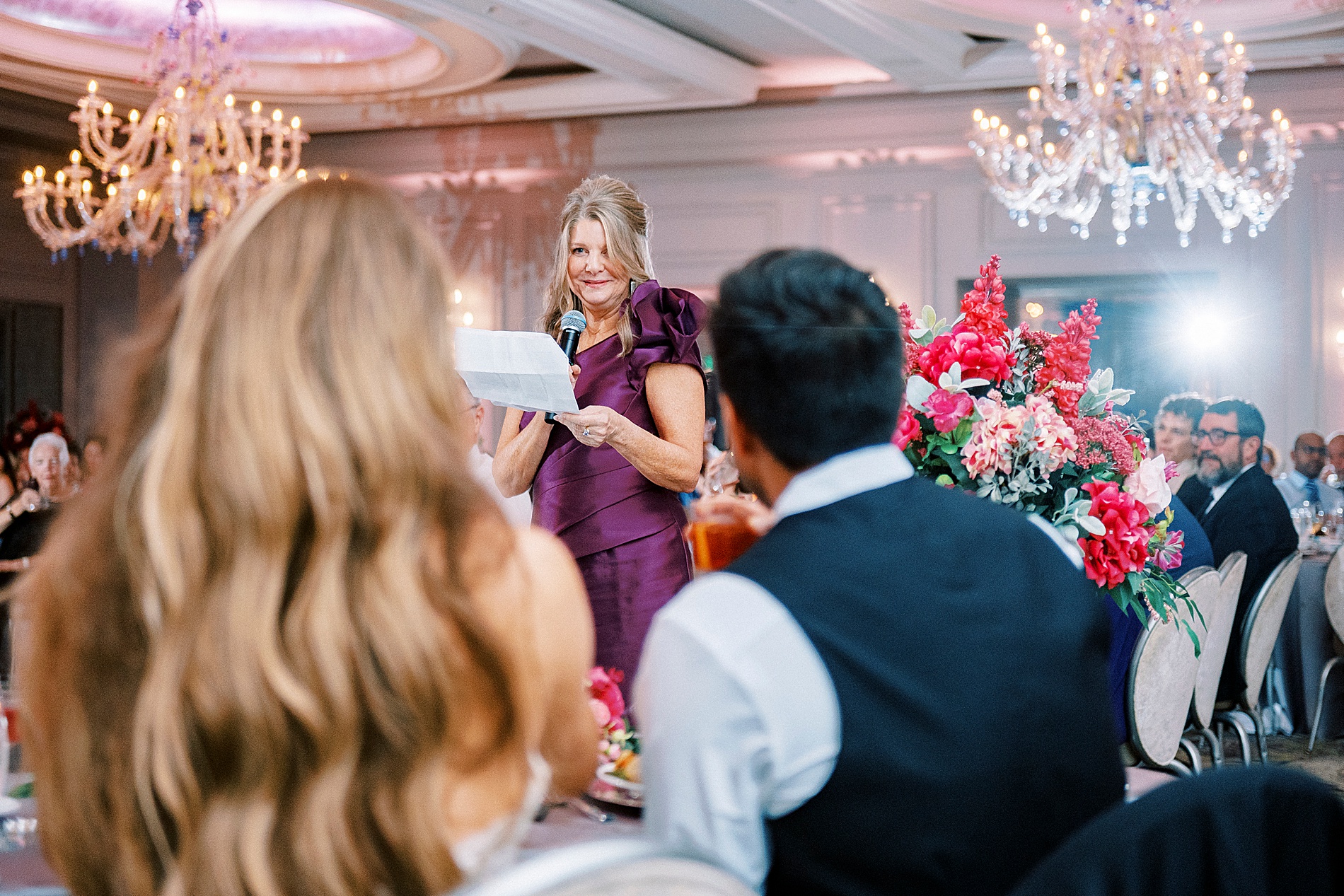 newlyweds listen to wedding speeches 