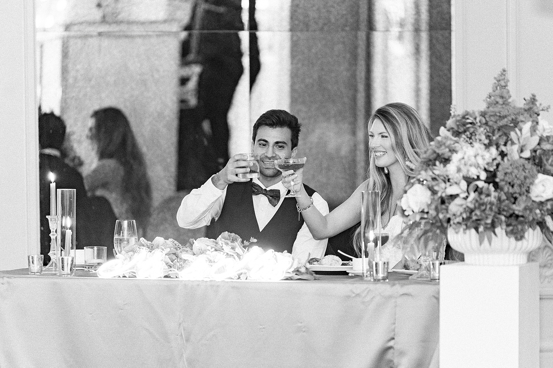 newlyweds raise their glasses during toasts 
