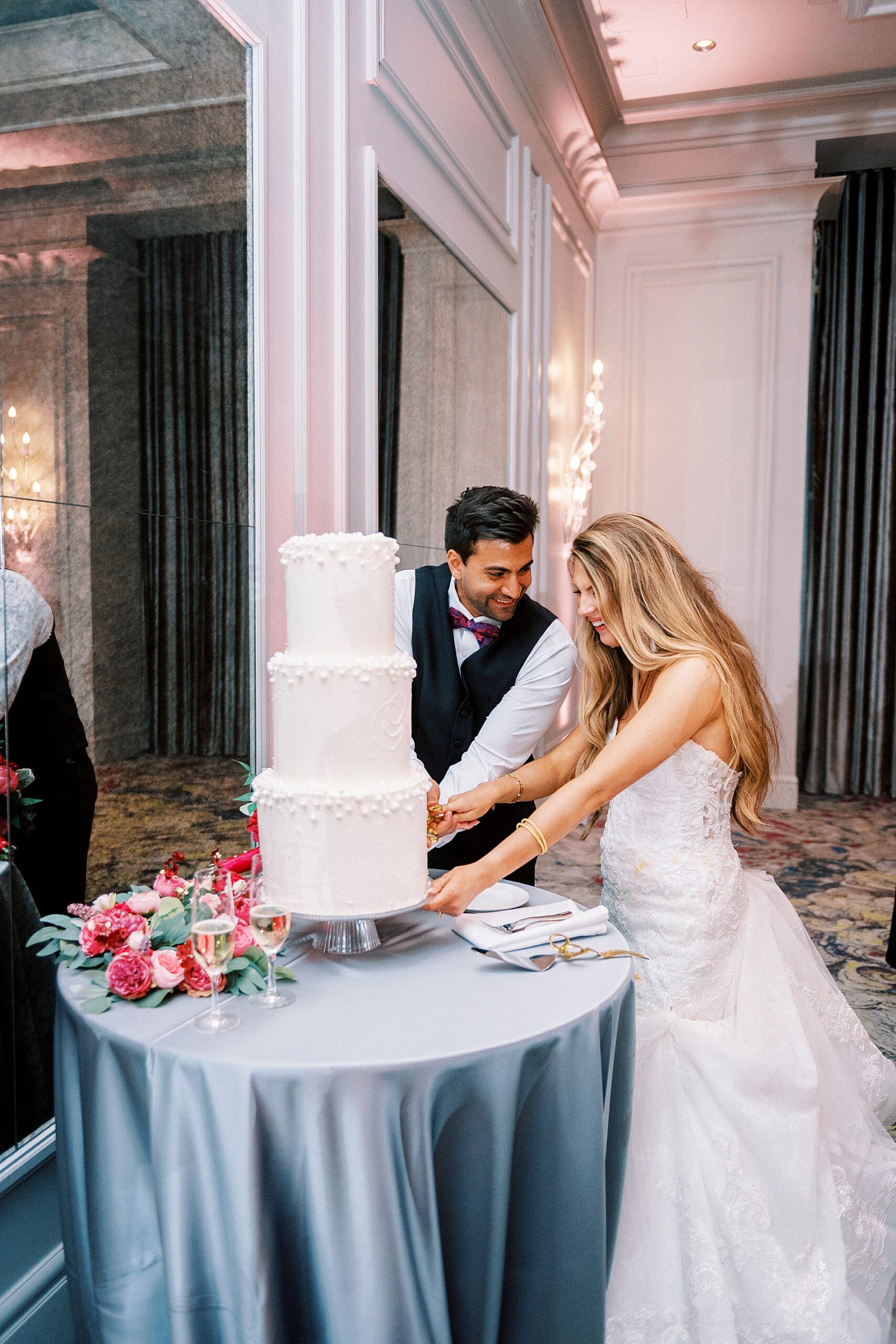 bride and groom cut wedding cake 