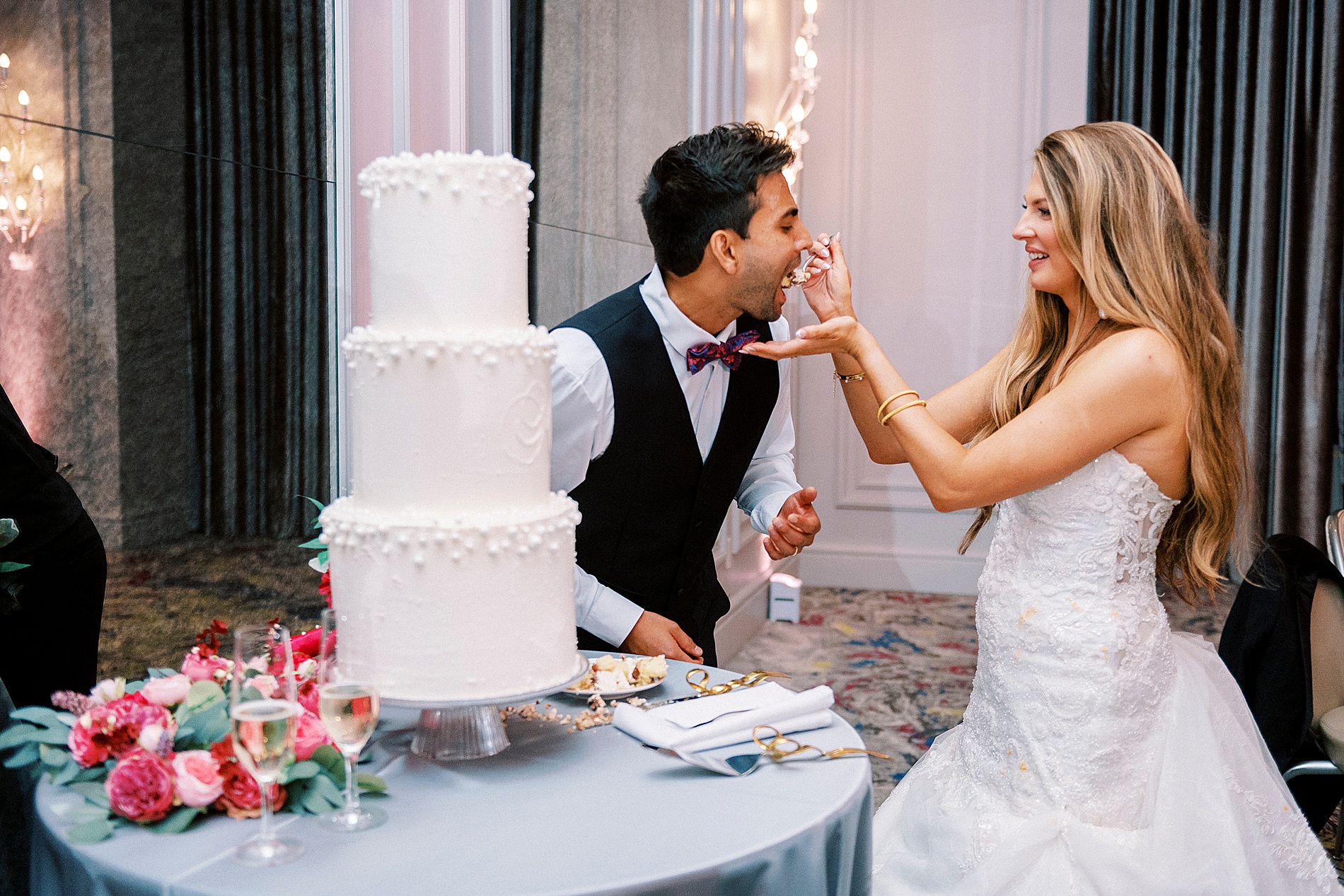 bride feeds groom cake
