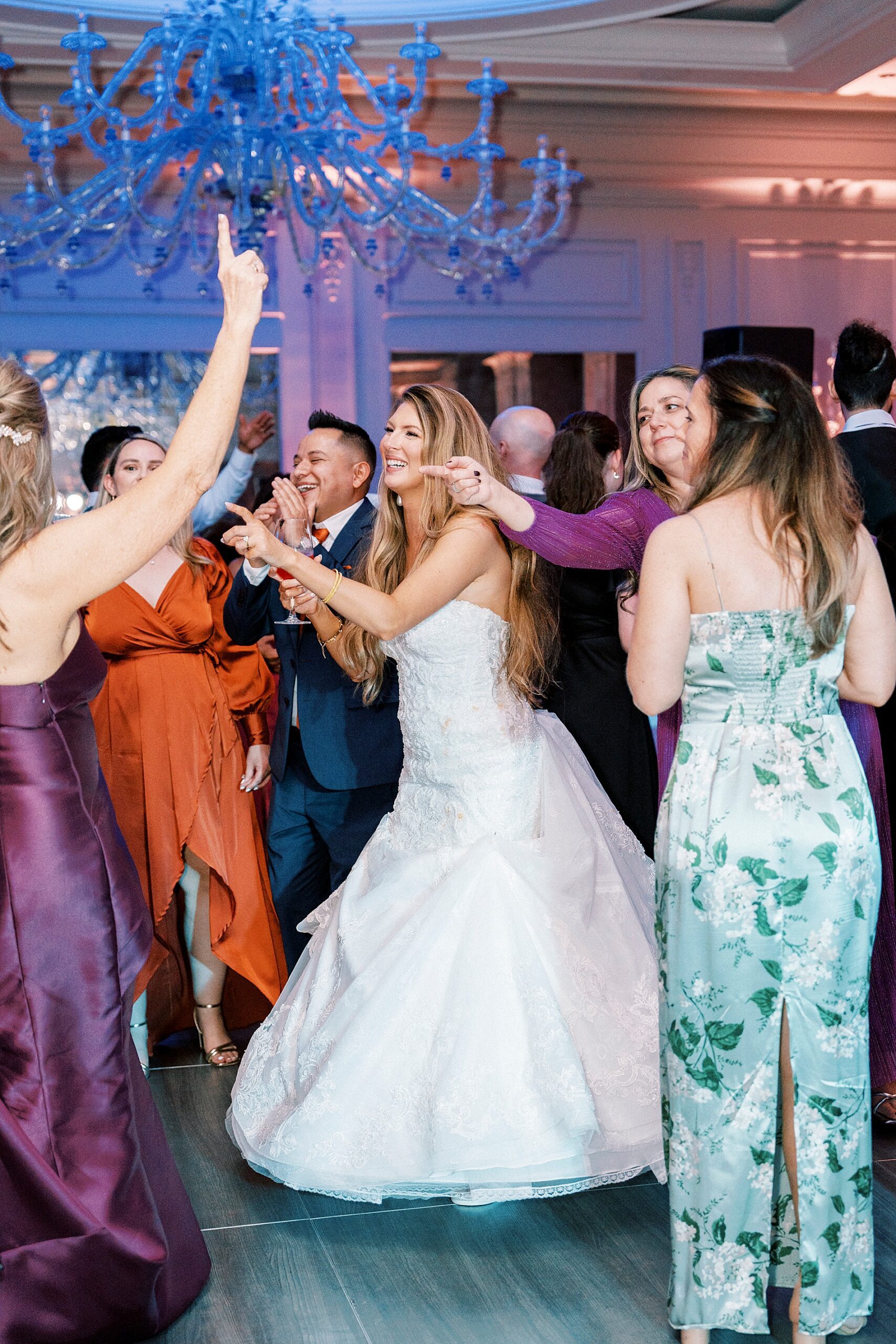 bride and groom on dance floor with guests 