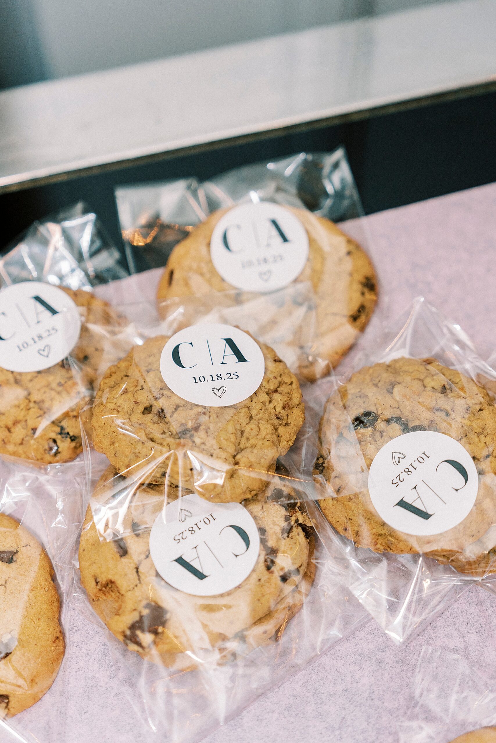 cookies with label on them featuring couples initials and wedding date 