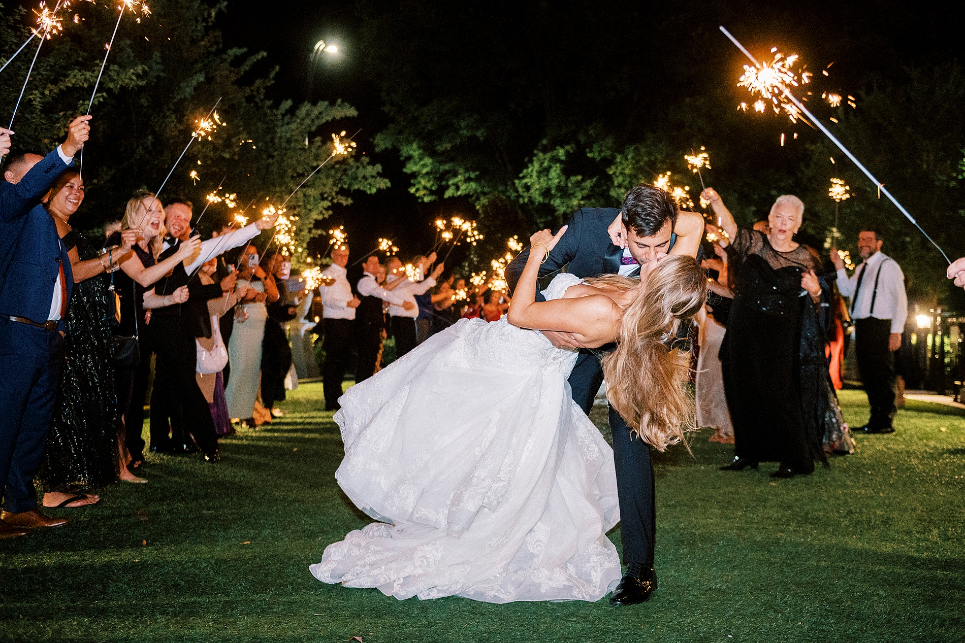 newlyweds kiss during sparkler exit  
