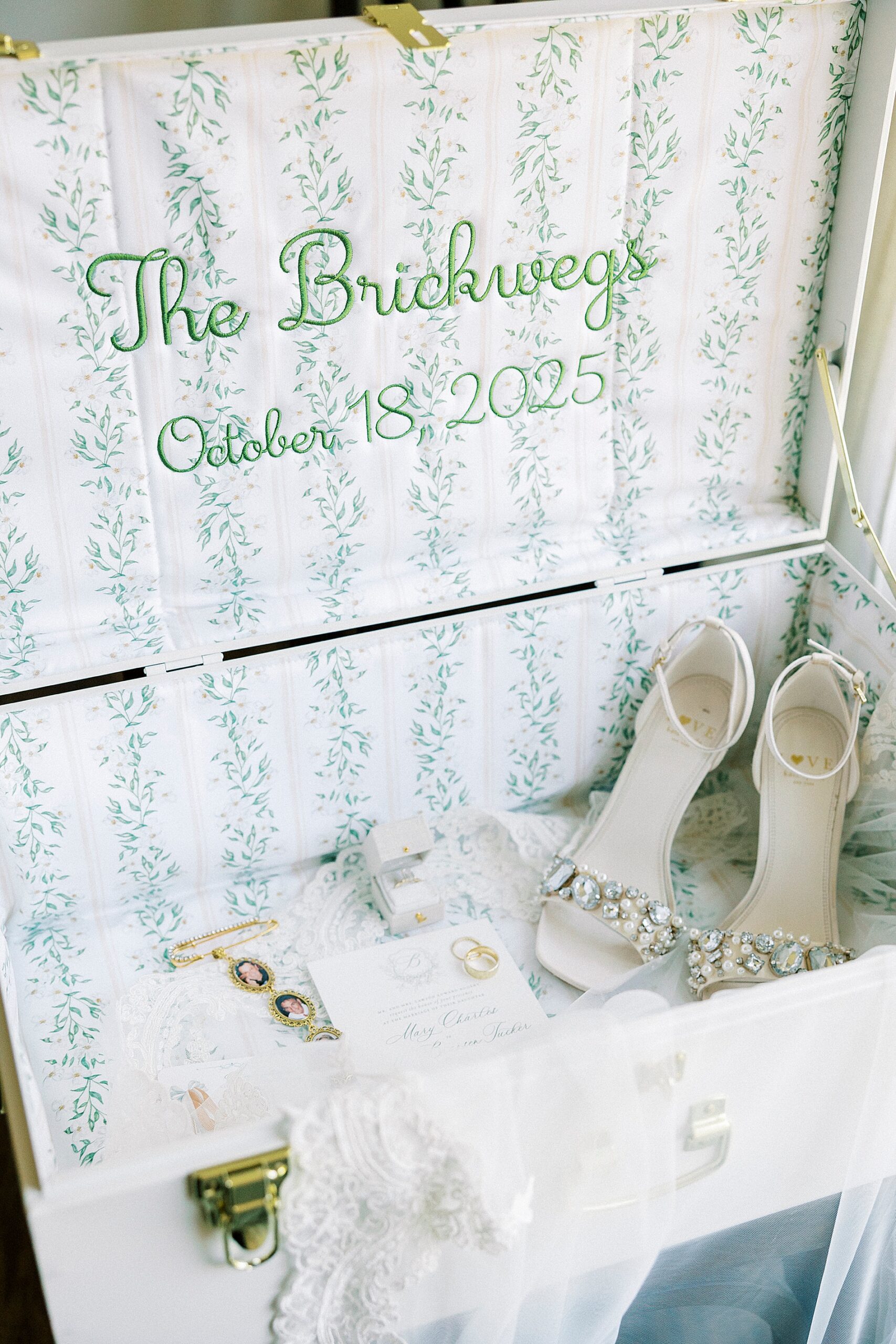 bridal details in box with details stitched into fabric 