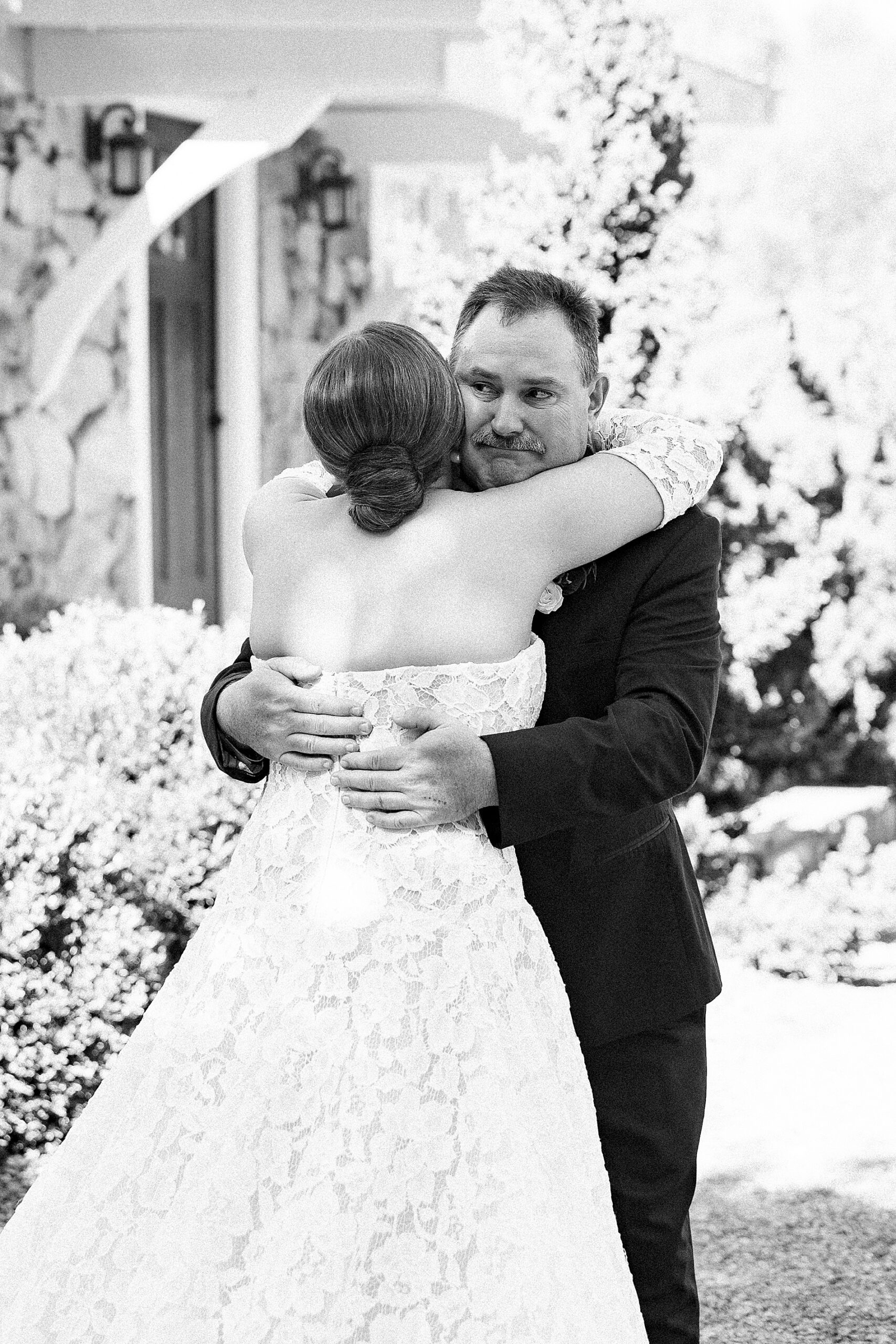 bride hugs father during first look